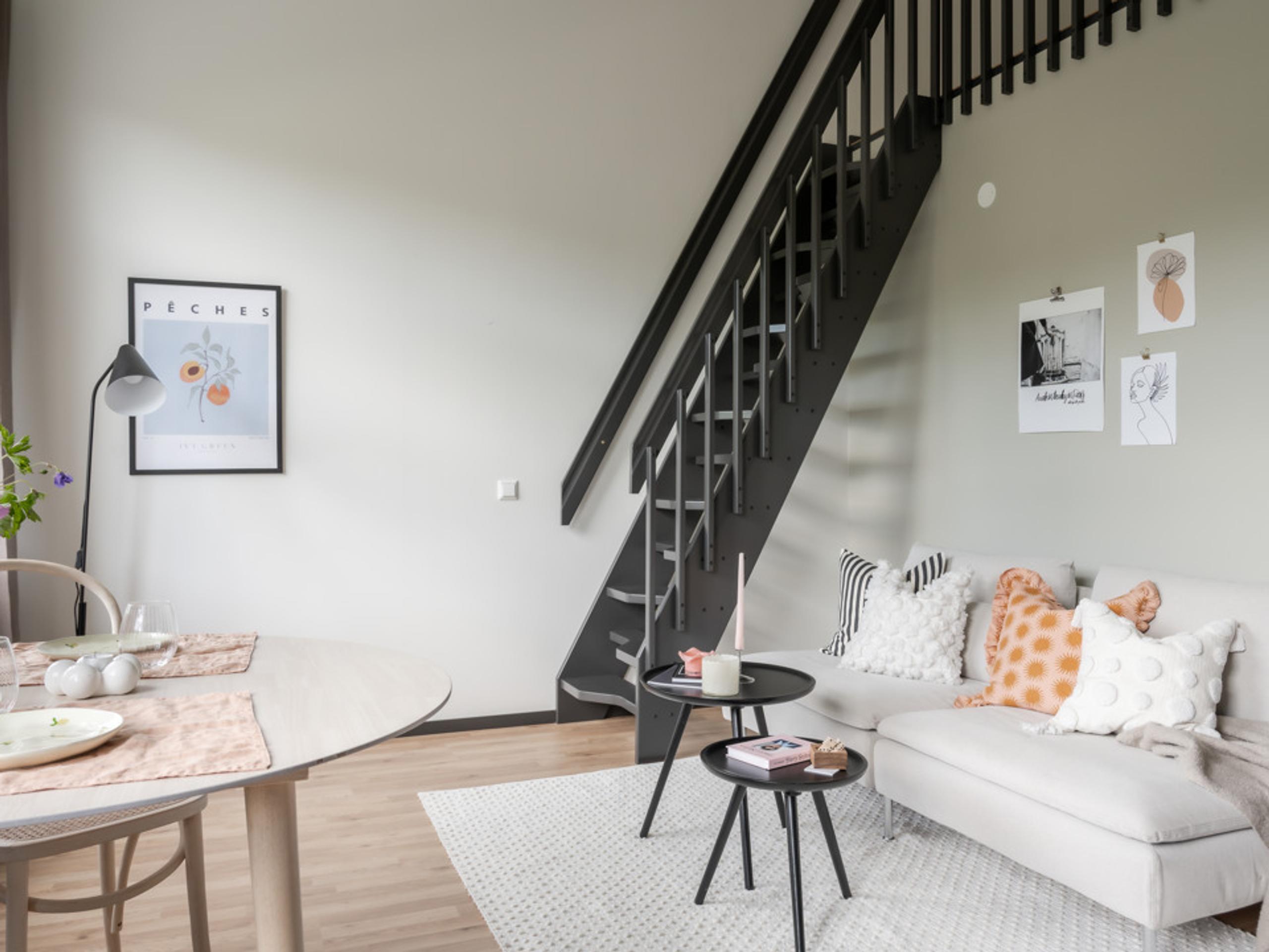 living room filled with furniture and a staircase.