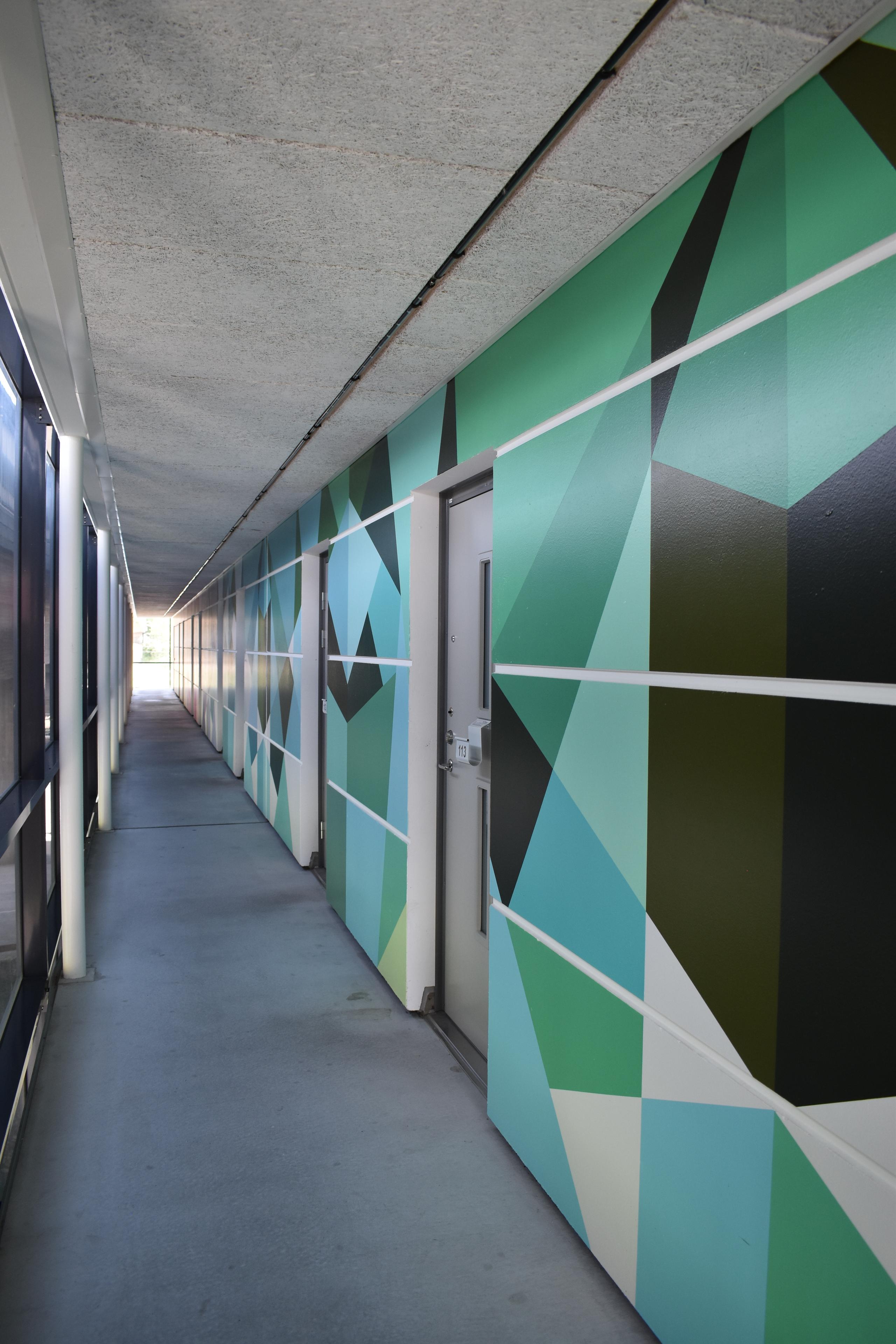 Student corridor. Walls painted in a blue, green and black pattern