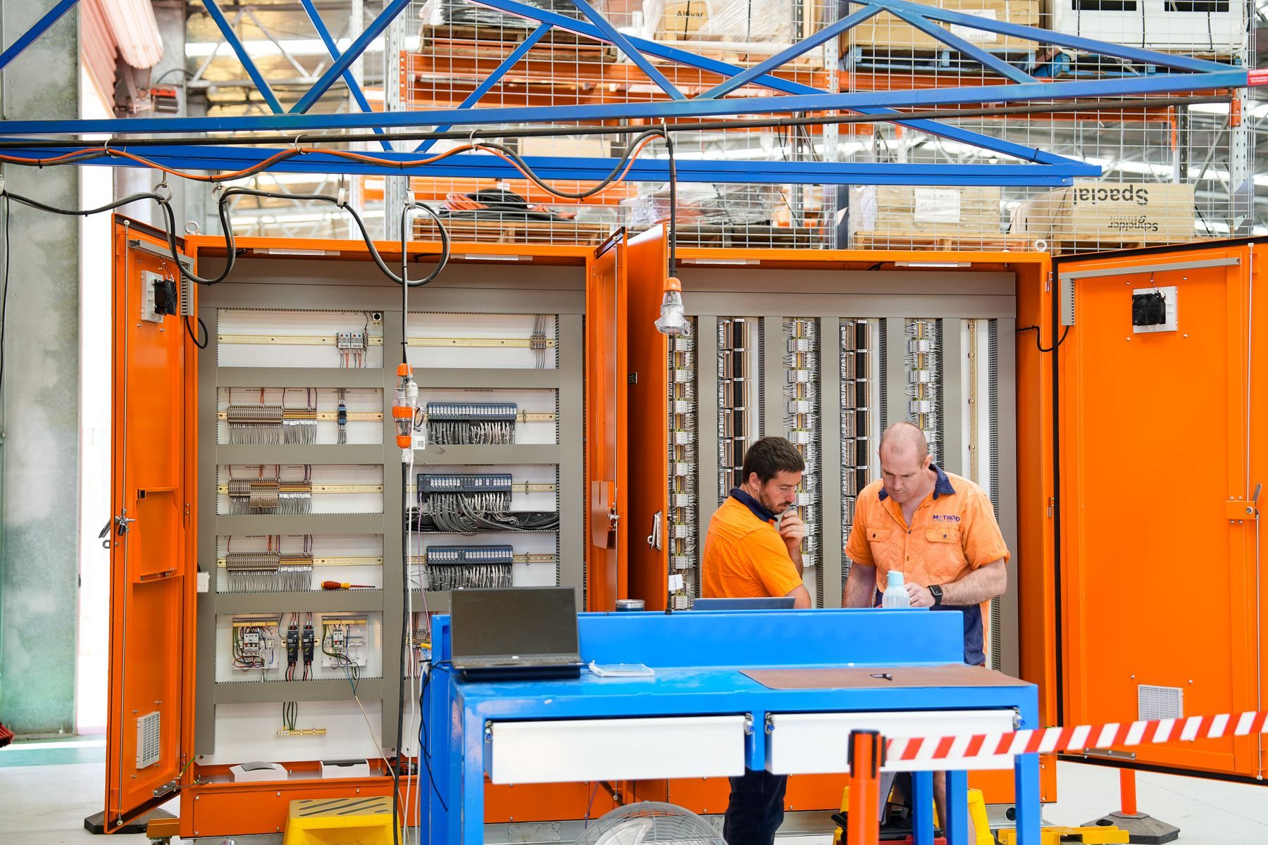 Two Metroid technicians reviewing an electrical control cabinet​​​​‌﻿‍﻿​‍​‍‌‍﻿﻿‌﻿​‍‌‍‍‌‌‍‌﻿‌‍‍‌‌‍﻿‍​‍​‍​﻿‍‍​‍​‍‌﻿​﻿‌‍​‌‌‍﻿‍‌‍‍‌‌﻿‌​‌﻿‍‌​‍﻿‍‌‍‍‌‌‍﻿﻿​‍​‍​‍﻿​​‍​‍‌‍‍​‌﻿​‍‌‍‌‌‌‍‌‍​‍​‍​﻿‍‍​‍​‍‌‍​‌‌‍​‍‌‍​﻿​﻿​‌​﻿​‍​﻿​﻿​‍﻿﻿‌‍‍‌‌‍﻿‍‌﻿‌​‌‍‌‌‌‍﻿‍‌﻿‌​​‍﻿﻿‌‍‌‌‌‍‌​‌‍‍‌‌﻿‌​​‍﻿﻿‌‍﻿‌‌‍﻿﻿‌‍‌​‌‍‌‌​﻿﻿‌‌﻿​​‌﻿​‍‌‍‌‌‌﻿​﻿‌‍‌‌‌‍﻿‍‌﻿‌​‌‍​‌‌﻿‌​‌‍‍‌‌‍﻿﻿‌‍﻿‍​﻿‍﻿‌‍‍‌‌‍‌​​﻿﻿‌‌‍​﻿‌‍﻿﻿‌‍﻿‍‌﻿‌​‌‍​‌‌‍​﻿‌﻿‌​‌‌​​‌‍​‌‌‍‌﻿‌‍‌‌​﻿‍﻿‌﻿‌​‌﻿‍‌‌﻿​​‌‍‌‌​﻿﻿‌‌‍​﻿‌‍﻿﻿‌‍﻿‍‌﻿‌​‌‍​‌‌‍​﻿‌﻿‌​‌‌​​‌‍​‌‌‍‌﻿‌‍‌‌​﻿‍﻿‌﻿​​‌‍​‌‌﻿‌​‌‍‍​​﻿﻿‌‌‍‍​‌‍‌‌‌﻿​‍‌‍﻿﻿​‍﻿‍‌‍‍‌‌‍﻿‌‌‍​‌‌‍‌﻿‌‍‌‌​‍﻿‍‌‍​‌‌‍﻿​‌﻿‌​​﻿﻿﻿‌‍​‍‌‍​‌‌﻿​﻿‌‍‌‌‌‌‌‌‌﻿​‍‌‍﻿​​﻿﻿‌‌‍​‌‌‍​‍‌‍​﻿​﻿​‌​﻿​‍​﻿​﻿​‍‌‍‌‍‍‌‌‍‌​​﻿﻿‌‌‍​﻿‌‍﻿﻿‌‍﻿‍‌﻿‌​‌‍​‌‌‍​﻿‌﻿‌​‌‌​​‌‍​‌‌‍‌﻿‌‍‌‌​‍‌‍‌﻿‌​‌﻿‍‌‌﻿​​‌‍‌‌​﻿﻿‌‌‍​﻿‌‍﻿﻿‌‍﻿‍‌﻿‌​‌‍​‌‌‍​﻿‌﻿‌​‌‌​​‌‍​‌‌‍‌﻿‌‍‌‌​‍‌‍‌﻿​​‌‍​‌‌﻿‌​‌‍‍​​﻿﻿‌‌‍‍​‌‍‌‌‌﻿​‍‌‍﻿﻿​‍﻿‍‌‍‍‌‌‍﻿‌‌‍​‌‌‍‌﻿‌‍‌‌​‍﻿‍‌‍​‌‌‍﻿​‌﻿‌​​‍‌‍‌﻿​​‌‍‌‌‌﻿​‍‌﻿​﻿‌﻿​​‌‍‌‌‌‍​﻿‌﻿‌​‌‍‍‌‌﻿‌‍‌‍‌‌​﻿﻿‌‌﻿​​‌﻿‌‌‌‍​‍‌‍﻿​‌‍‍‌‌﻿​﻿‌‍‍​‌‍‌‌‌‍‌​​‍​‍‌﻿﻿‌