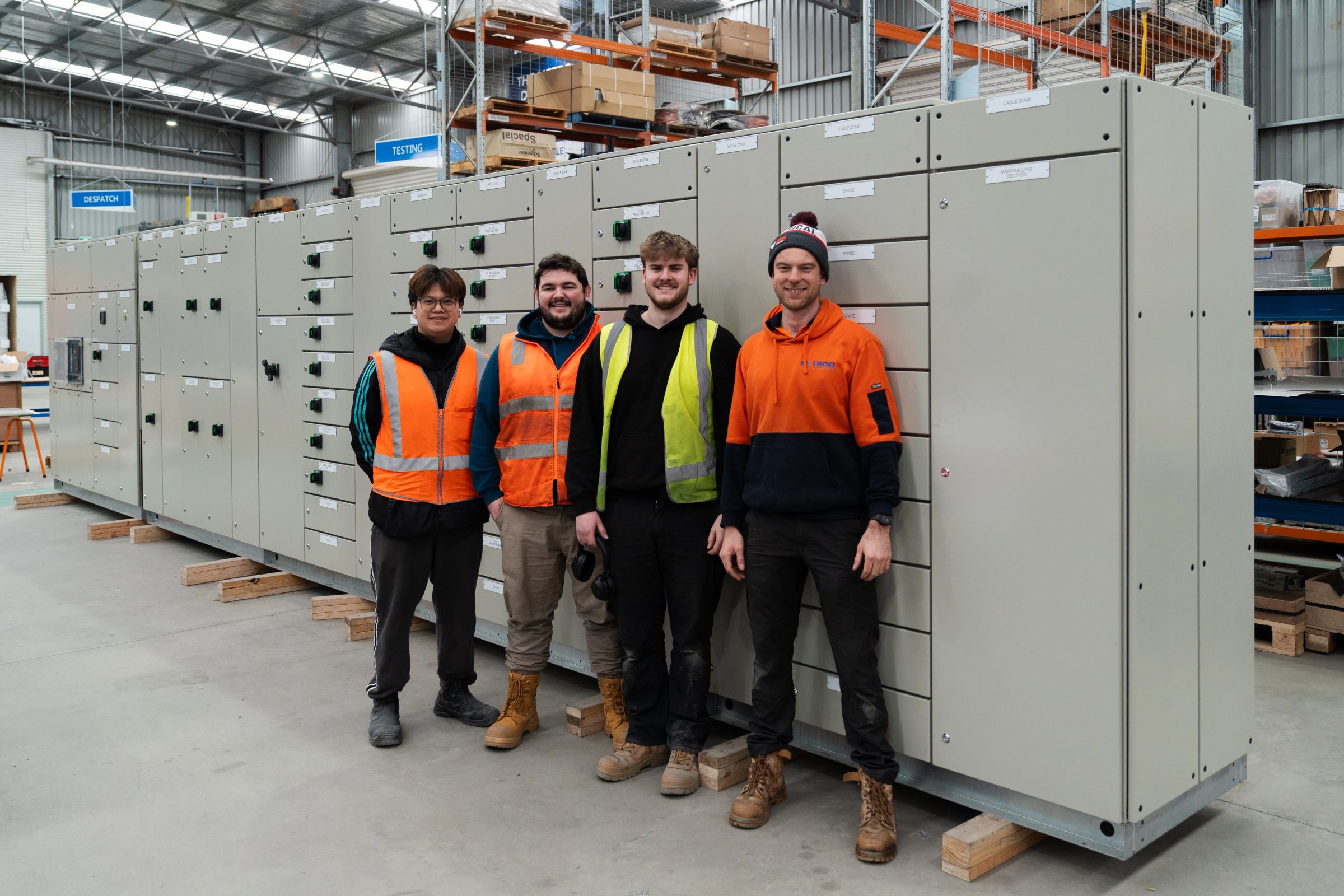 Two Metroid technicians reviewing an electrical control cabinet