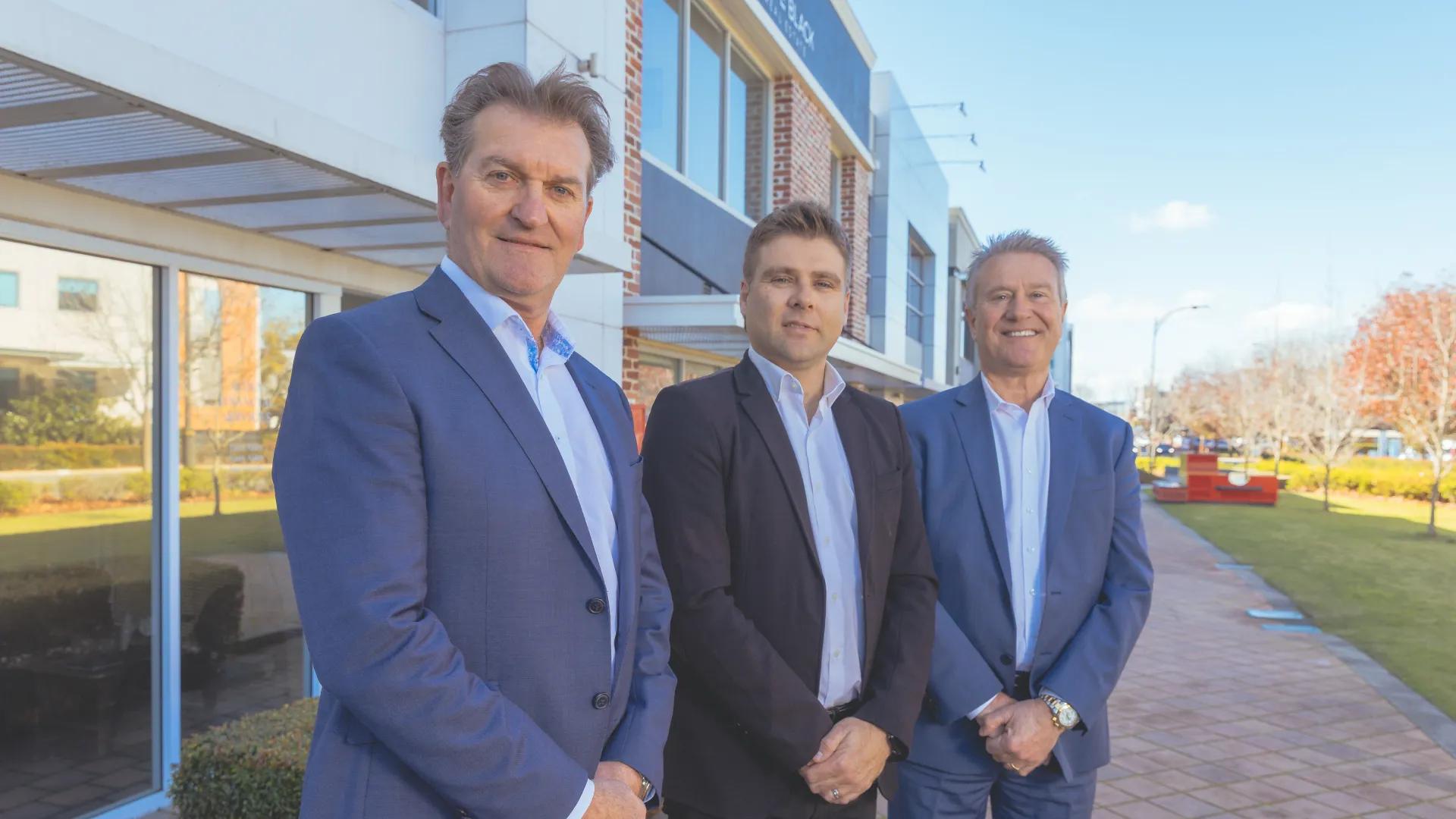 A photo of the three directors of Agnew Financial Group standing outside.
