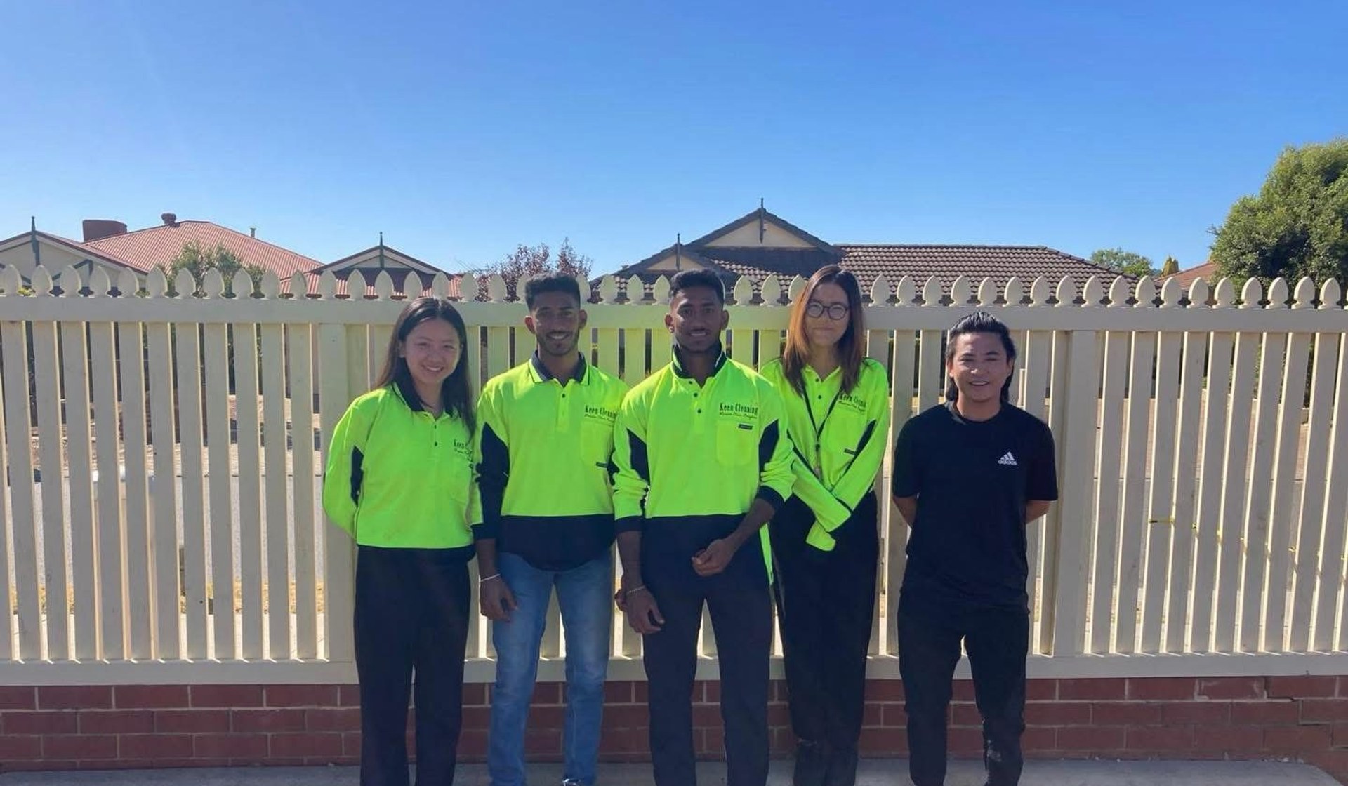 Keen Cleaning team members in uniform standing together outdoors