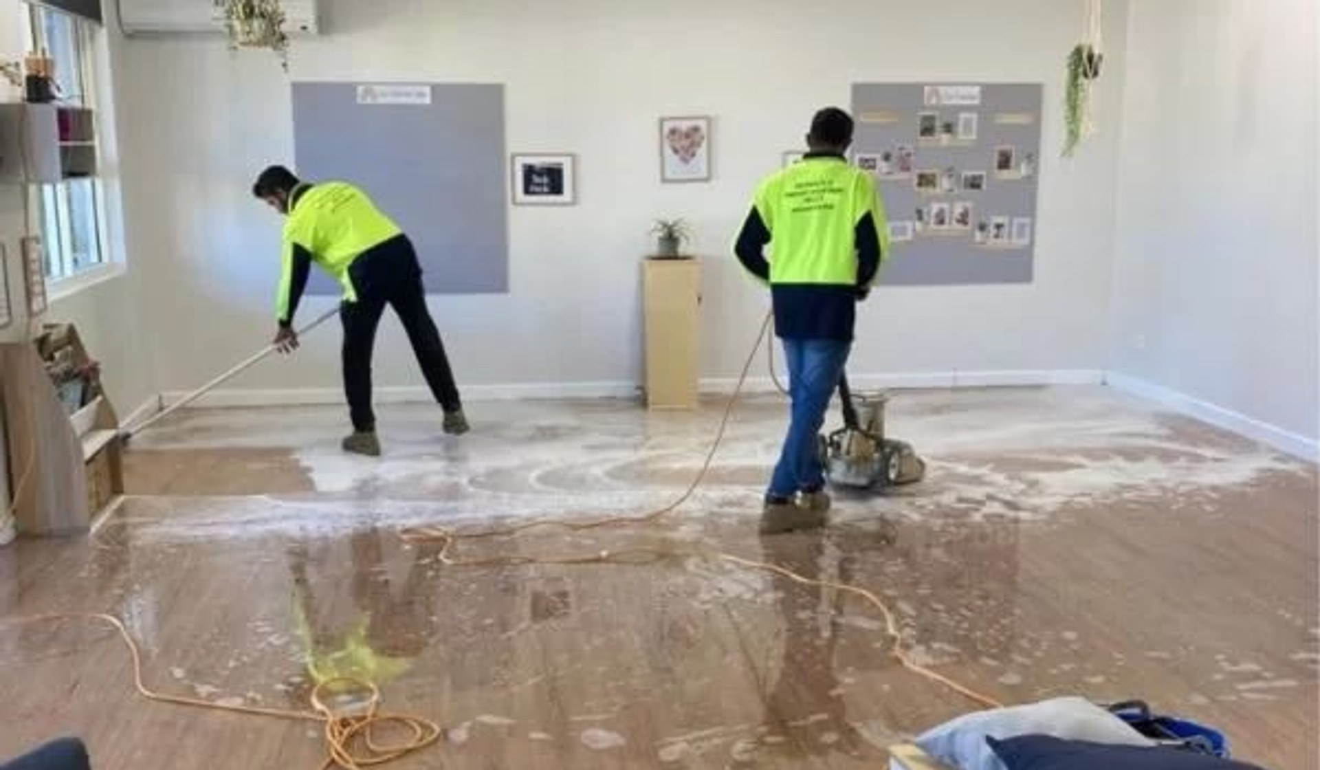 Commercial cleaning team maintaining a workplace floor