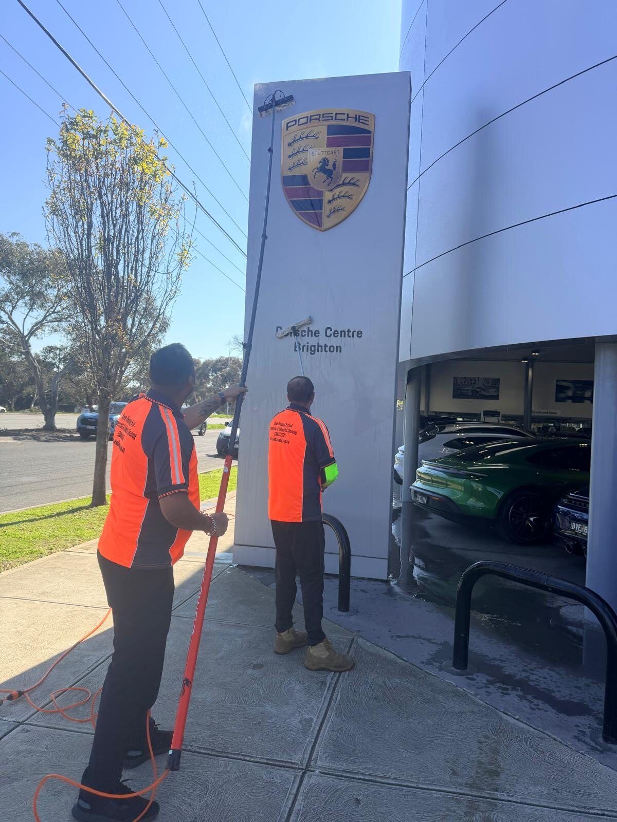 Keen Cleaning team washing the Porsche Centre Brighton monument sign