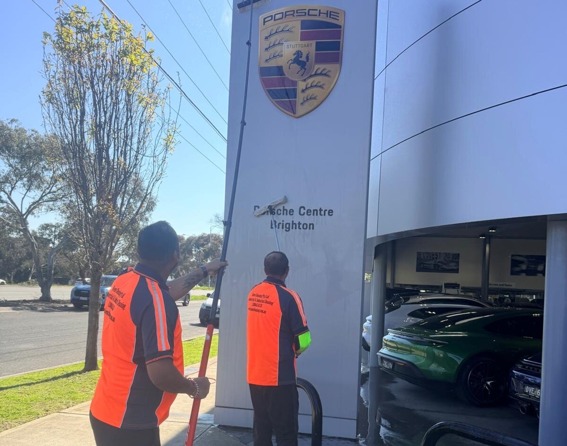 Keen Cleaning team washing the Porsche Centre Brighton monument sign
