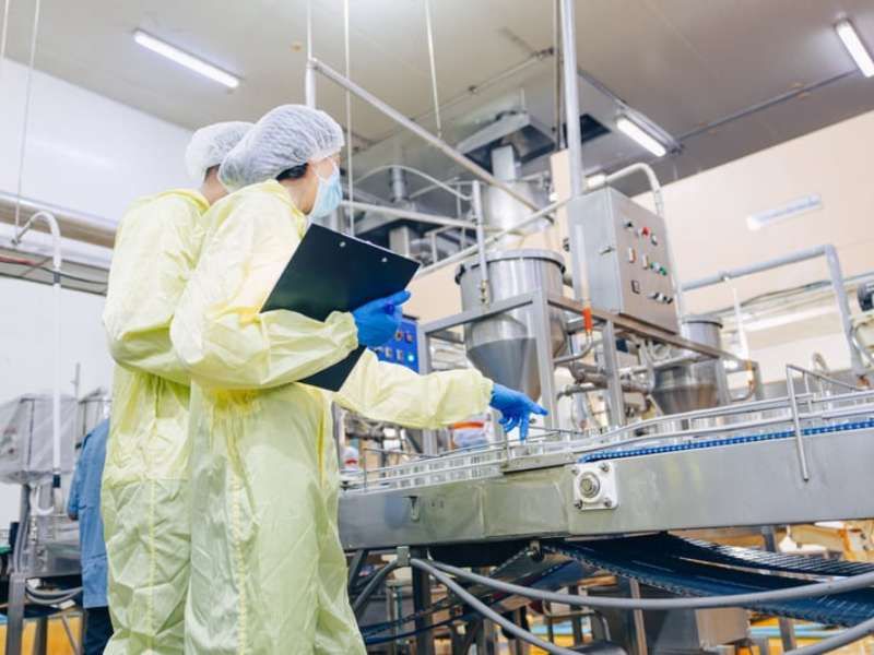 Modern food manufacturing plant interior — stainless-steel equipment and production line