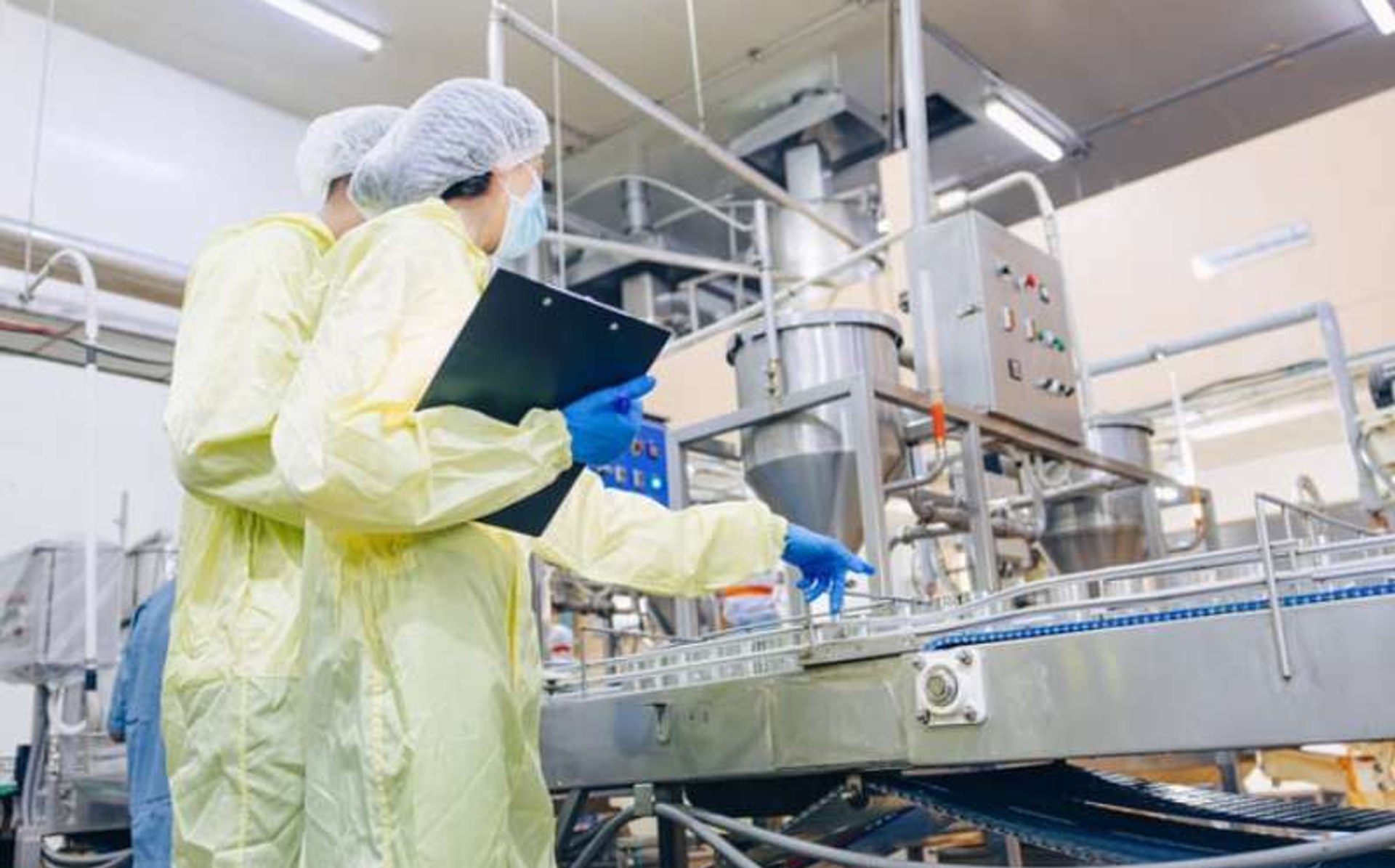 Modern food manufacturing plant interior — stainless-steel equipment and production line
