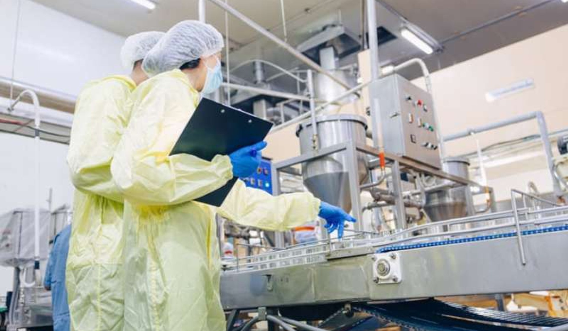 Modern food manufacturing plant interior — stainless-steel equipment and production line