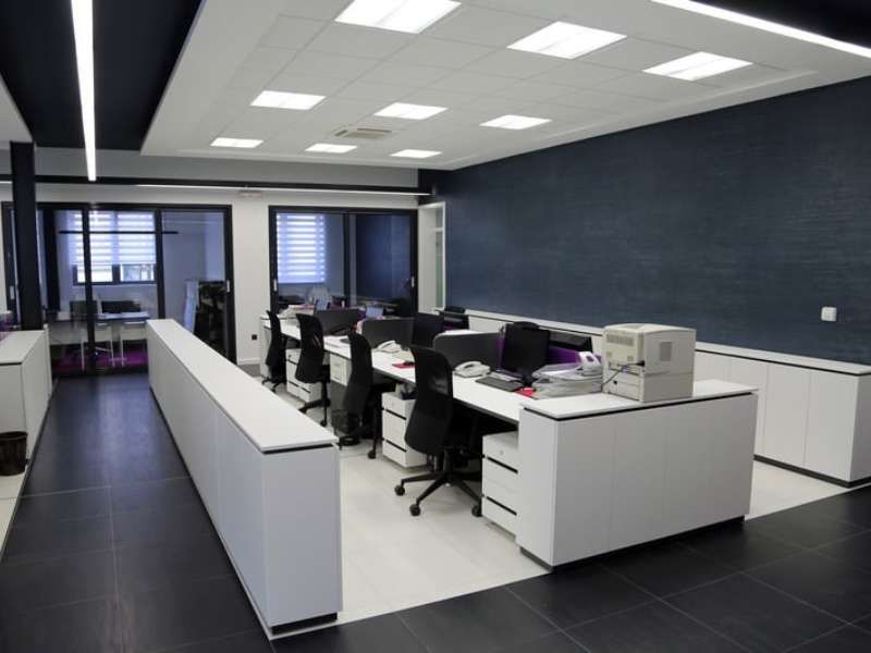 Modern open-plan corporate office with desks and meeting rooms