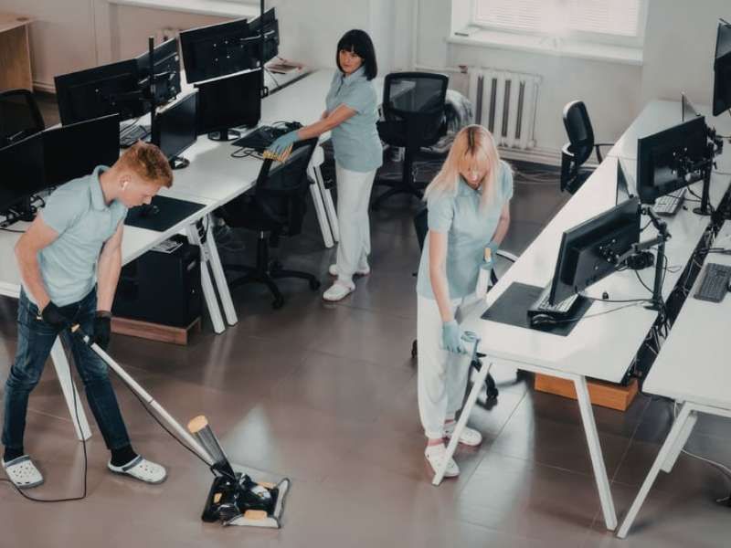 Professional commercial cleaner at work in office