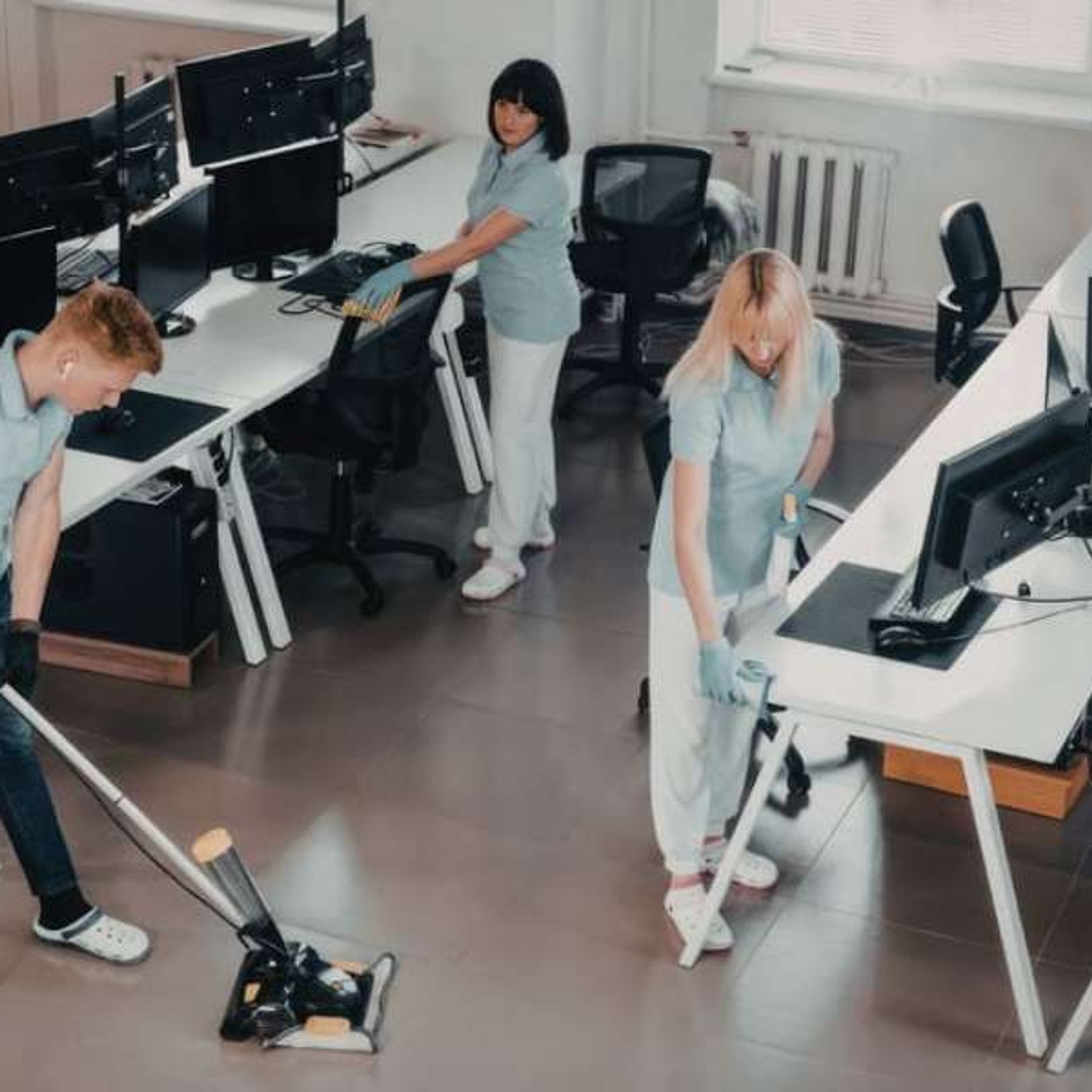 Professional commercial cleaner at work in office