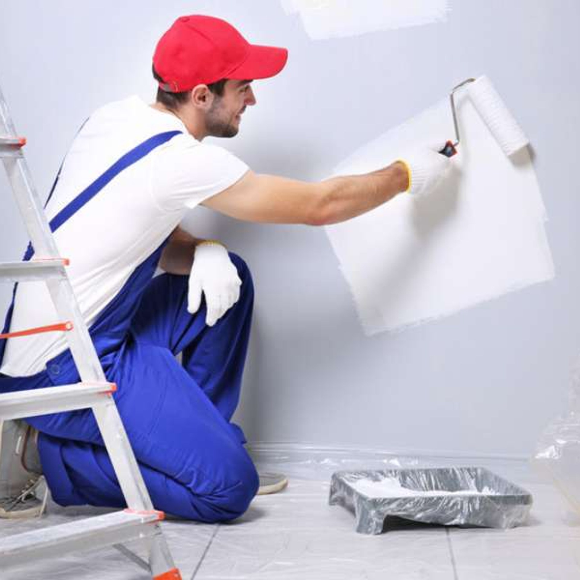 Painter using roller on freshly prepared wall