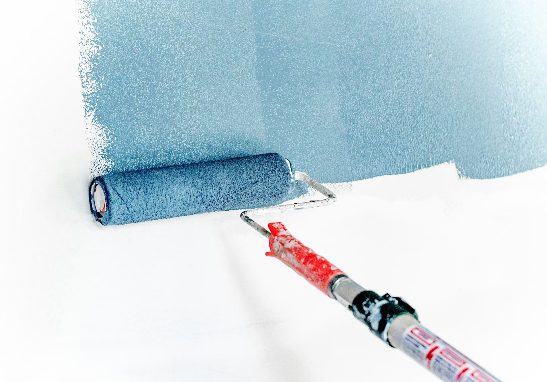 Professional painter painting interior wall — Keen Cleaning Australia