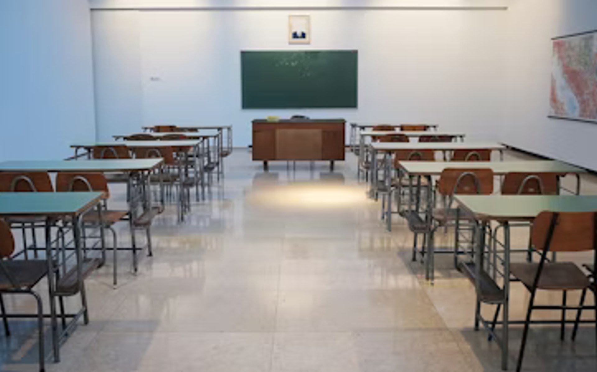 Bright clean modern school classroom with rows of desks