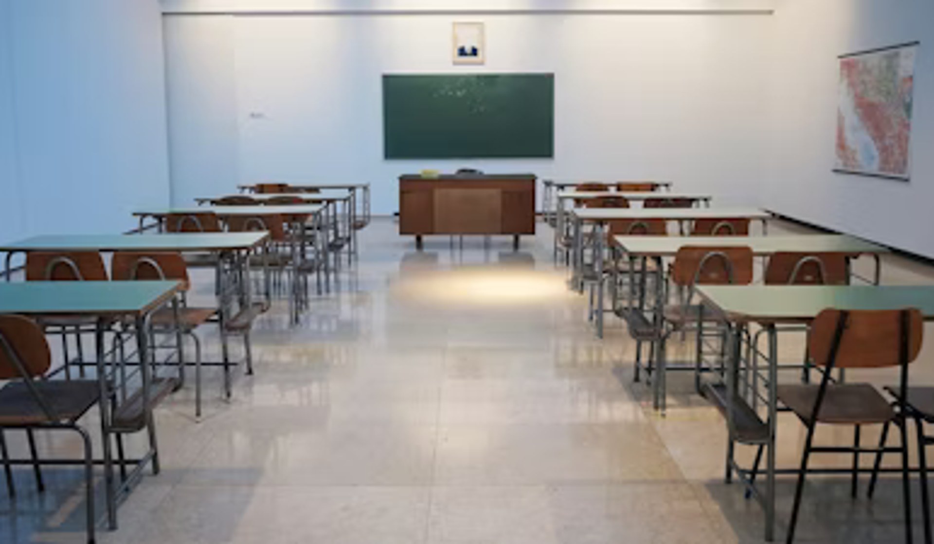 Bright clean modern school classroom with rows of desks
