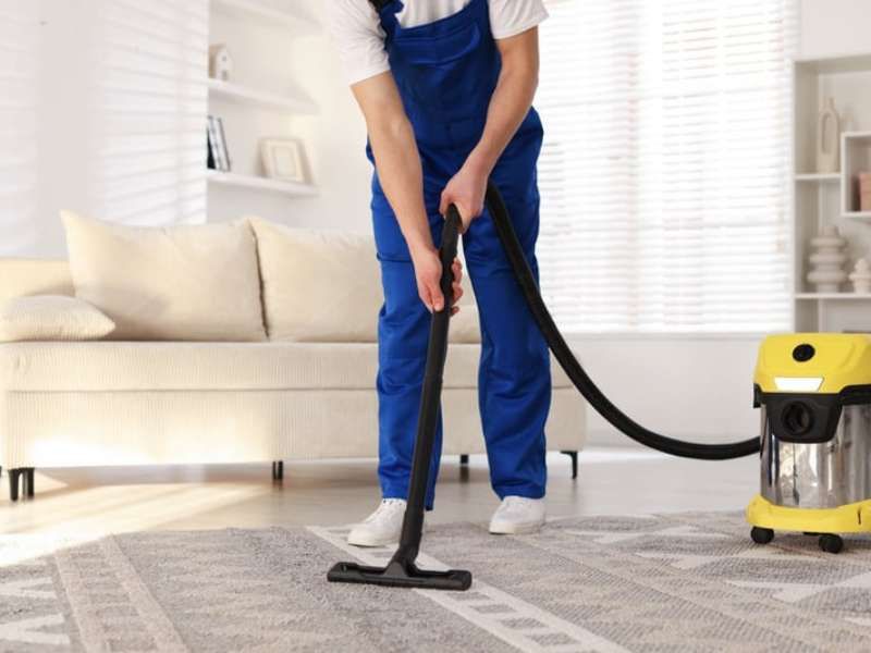 Professional strata cleaning service - cleaner sanitising apartment hallway