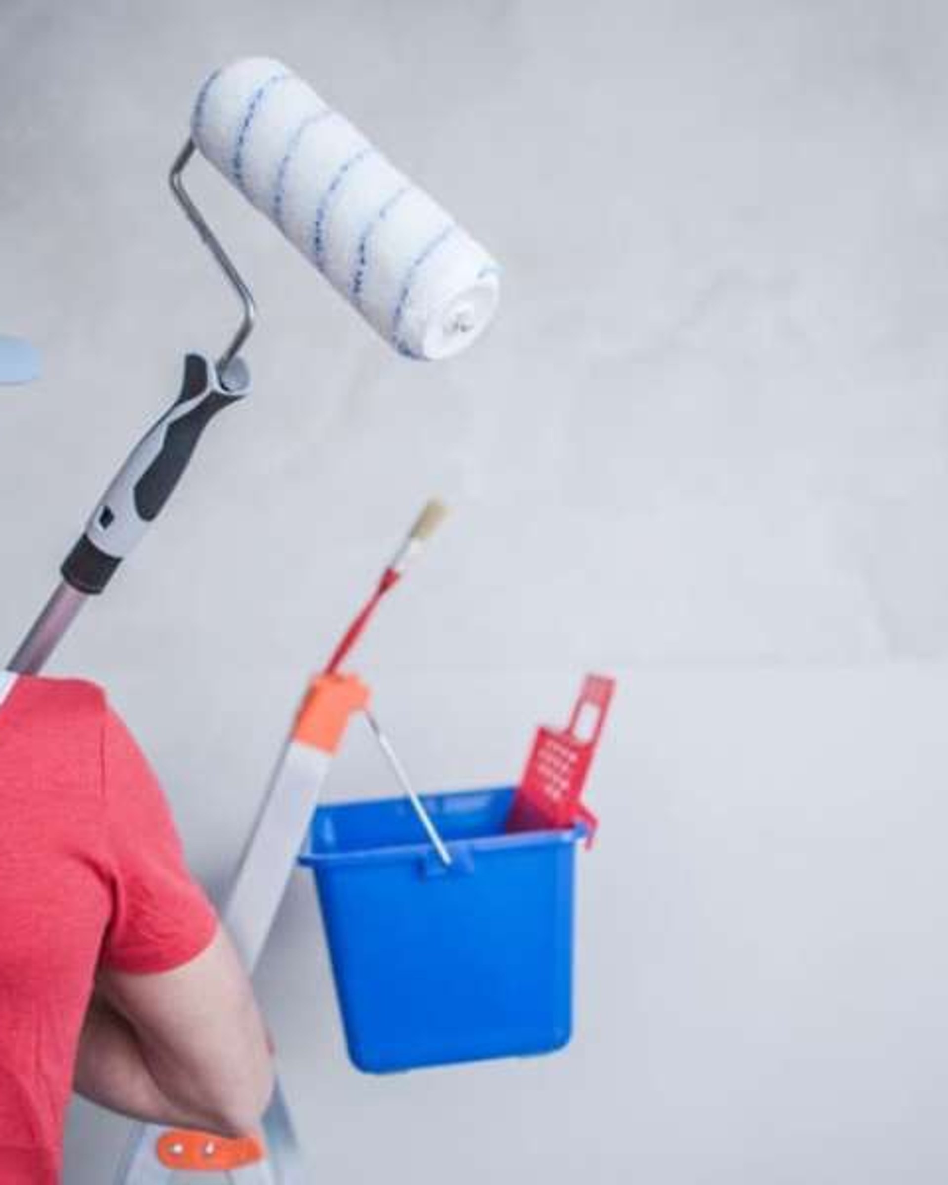 Professional painter painting a residential wall in Australia