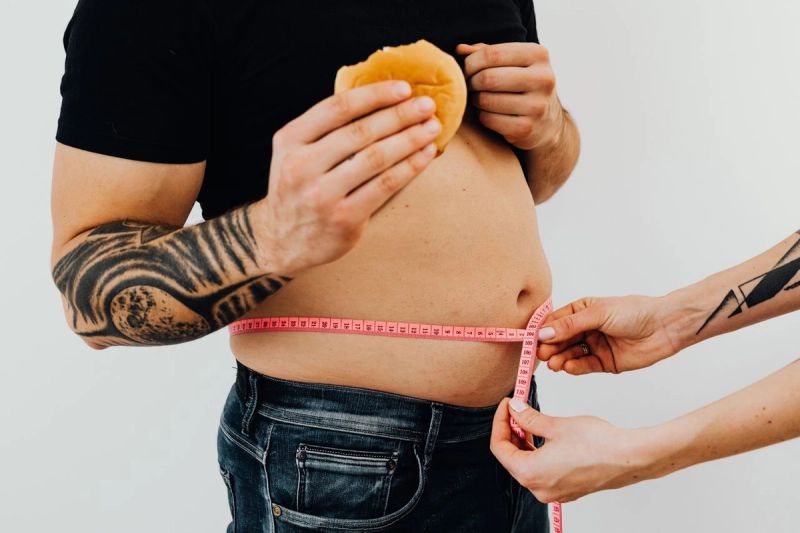 man with abdominal fat being measured