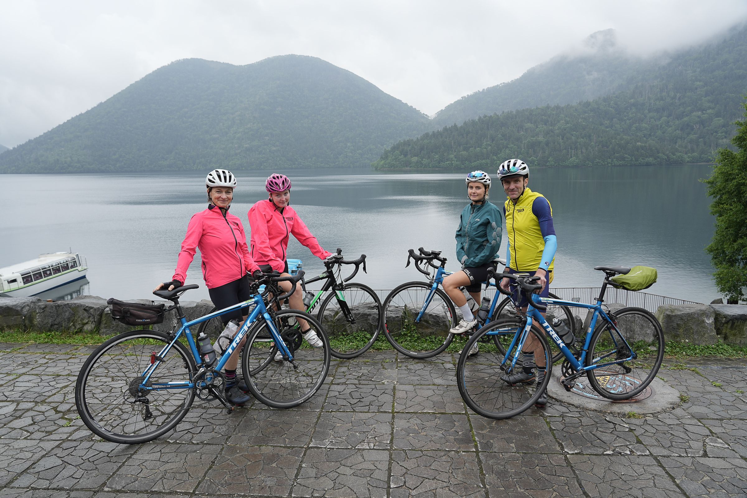 A family of cyclists stopped by Lake Shikaribetsu, Hokkaido.