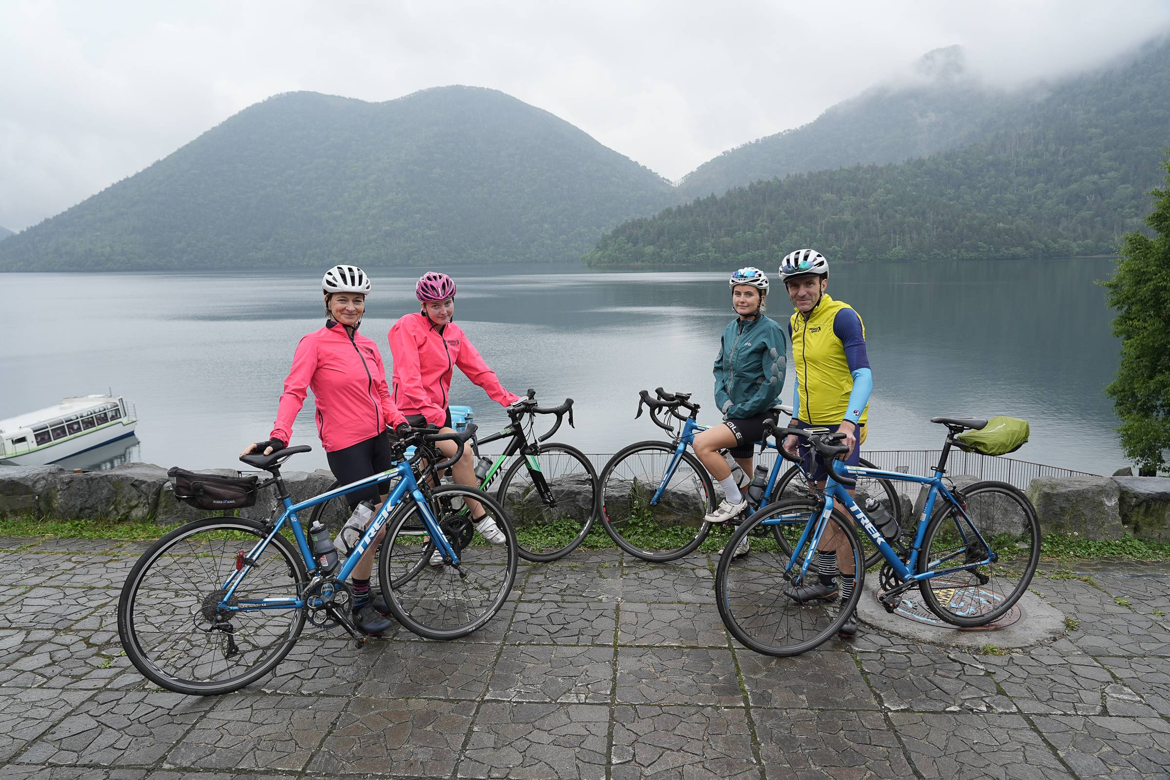 A family of cyclists stopped by Lake Shikaribetsu, Hokkaido.