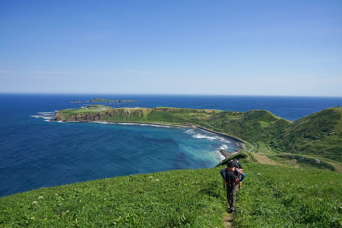 A hiker climbs with a sea view on Rebun