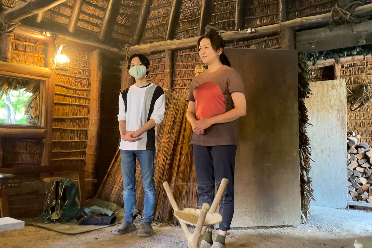 Visitors inside a traditional Ainu house in Asahikawa, Hokkaido.