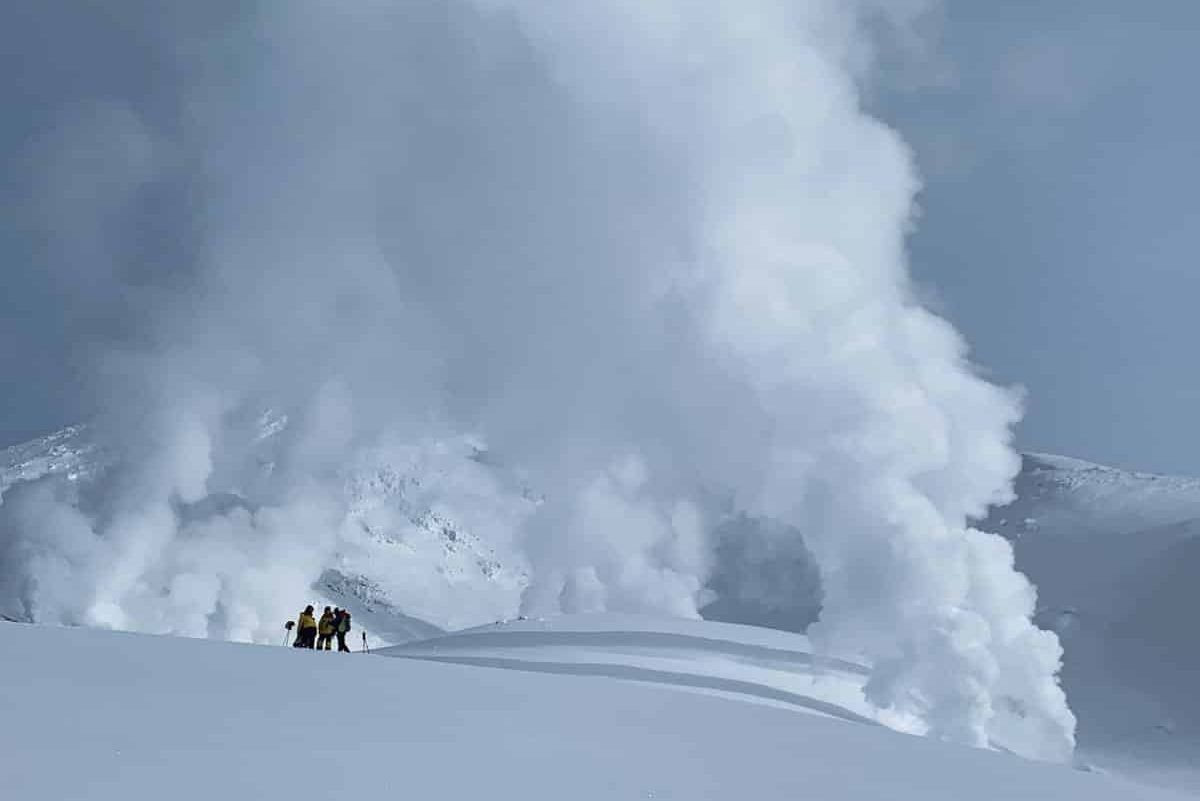 Hikers and steaming geysers of Mt Asahidake in winter