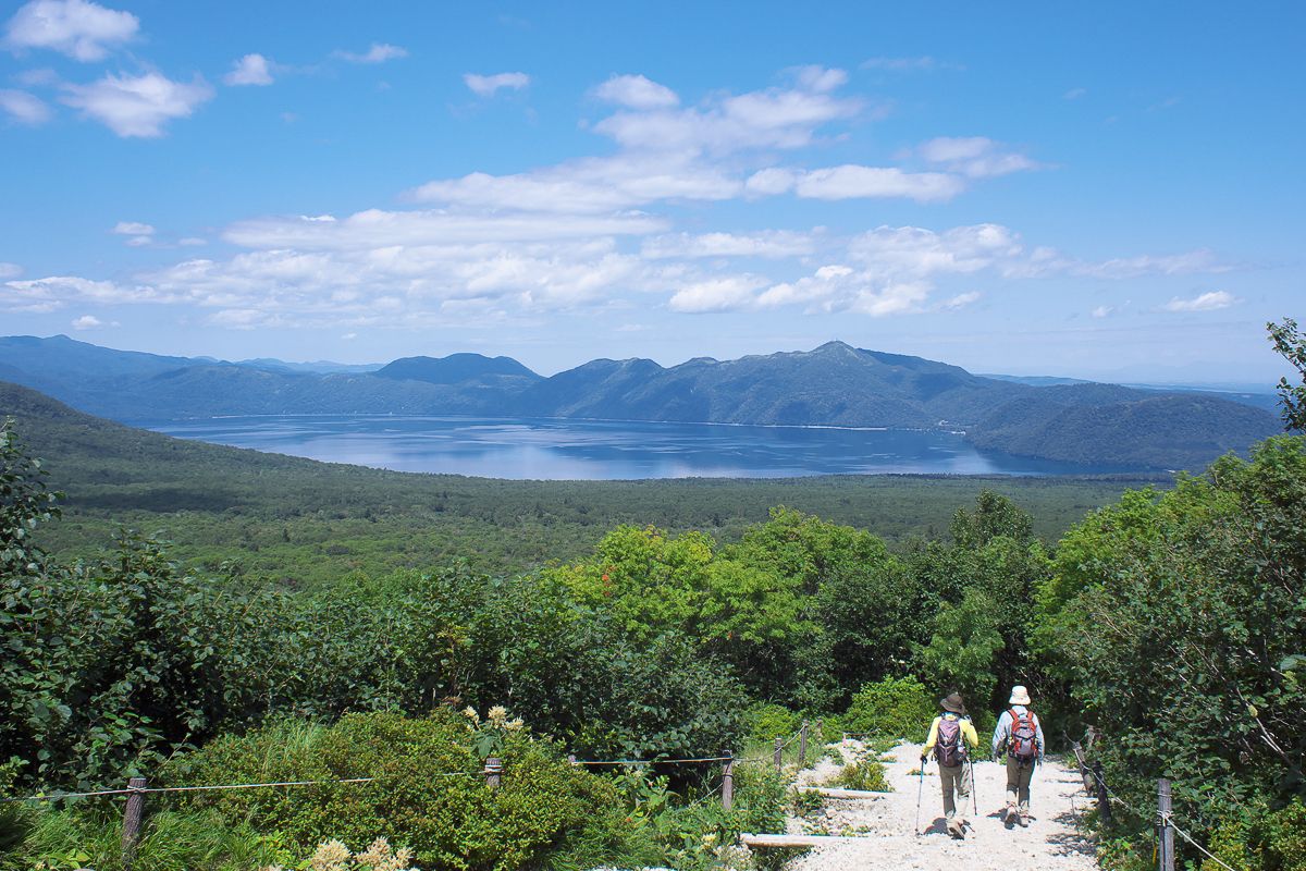 Hikers enjoying views of Lake Shikotsu on the Tarumaezan hiking trail in Hokkaido