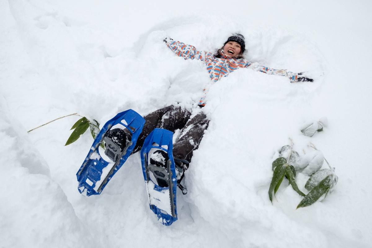 A snowshoer makes a snow angel at Mt. Asahidake
