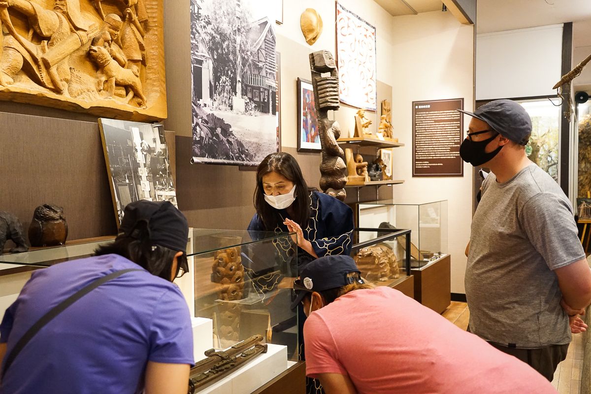 Visitors and guide at the Cise Ainu culture museum in Asahikawa, Hokkaido.