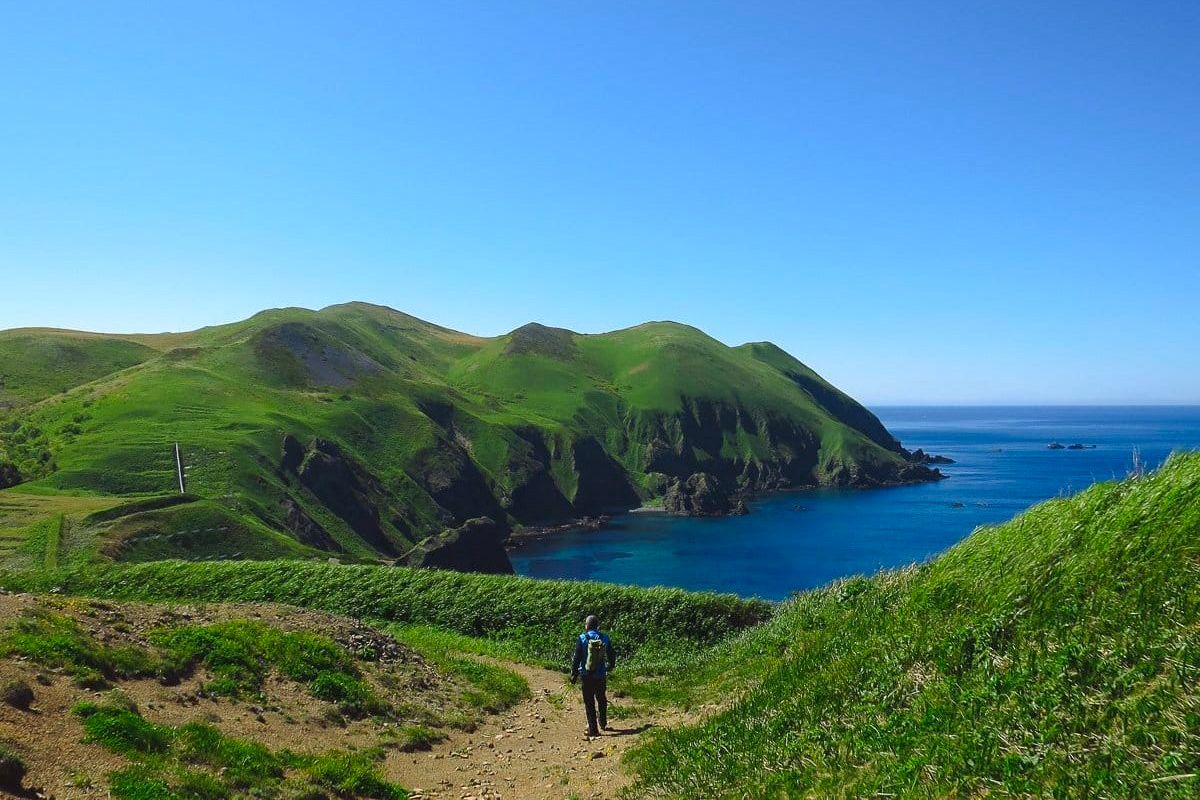 Hiker on coastal walkway of Rebun Island