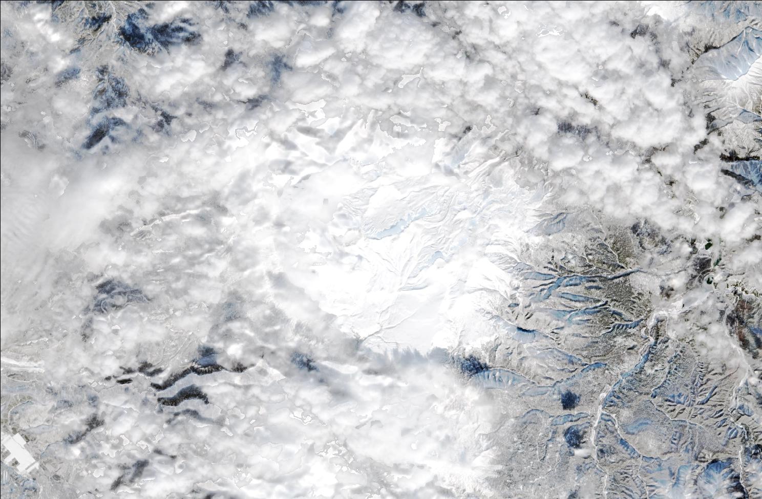 A satellite image showing snow over the northern Daisetsuzan mountains. Cloud covers most of the image, but snow can still be seen covering the landscape.