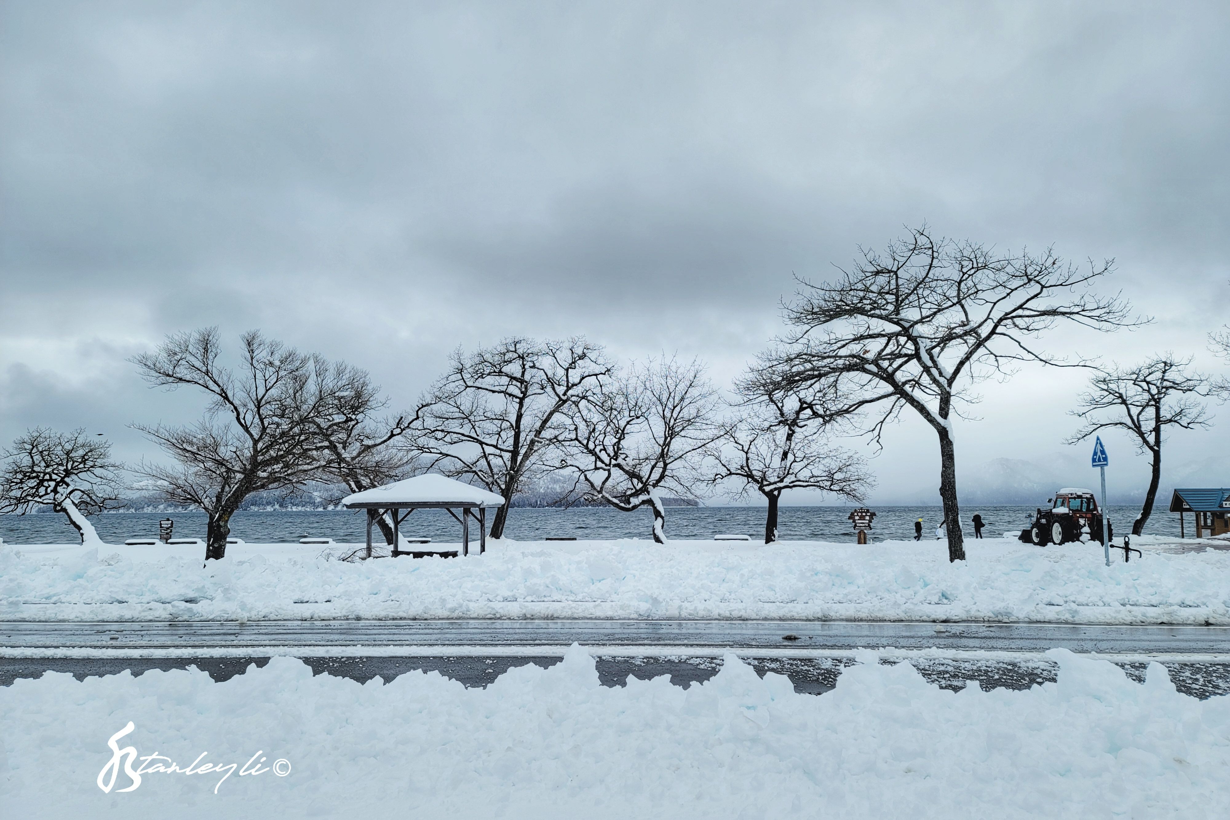 A gazebo is photographed under stormy skies by Lake Kussharo.
