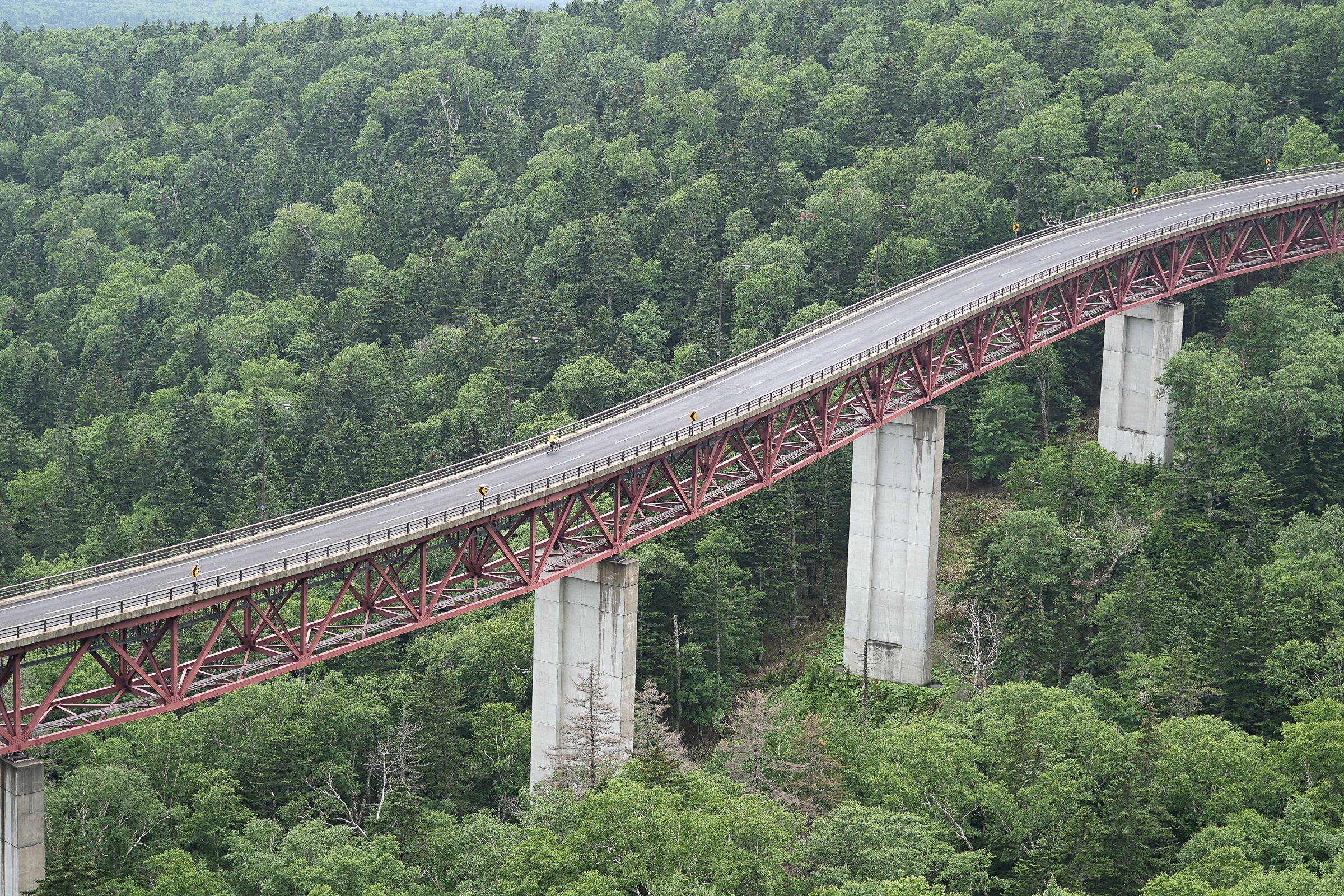 Cyclists riding up on the viaduct roads over Mikuni Pass, central Hokkaido.