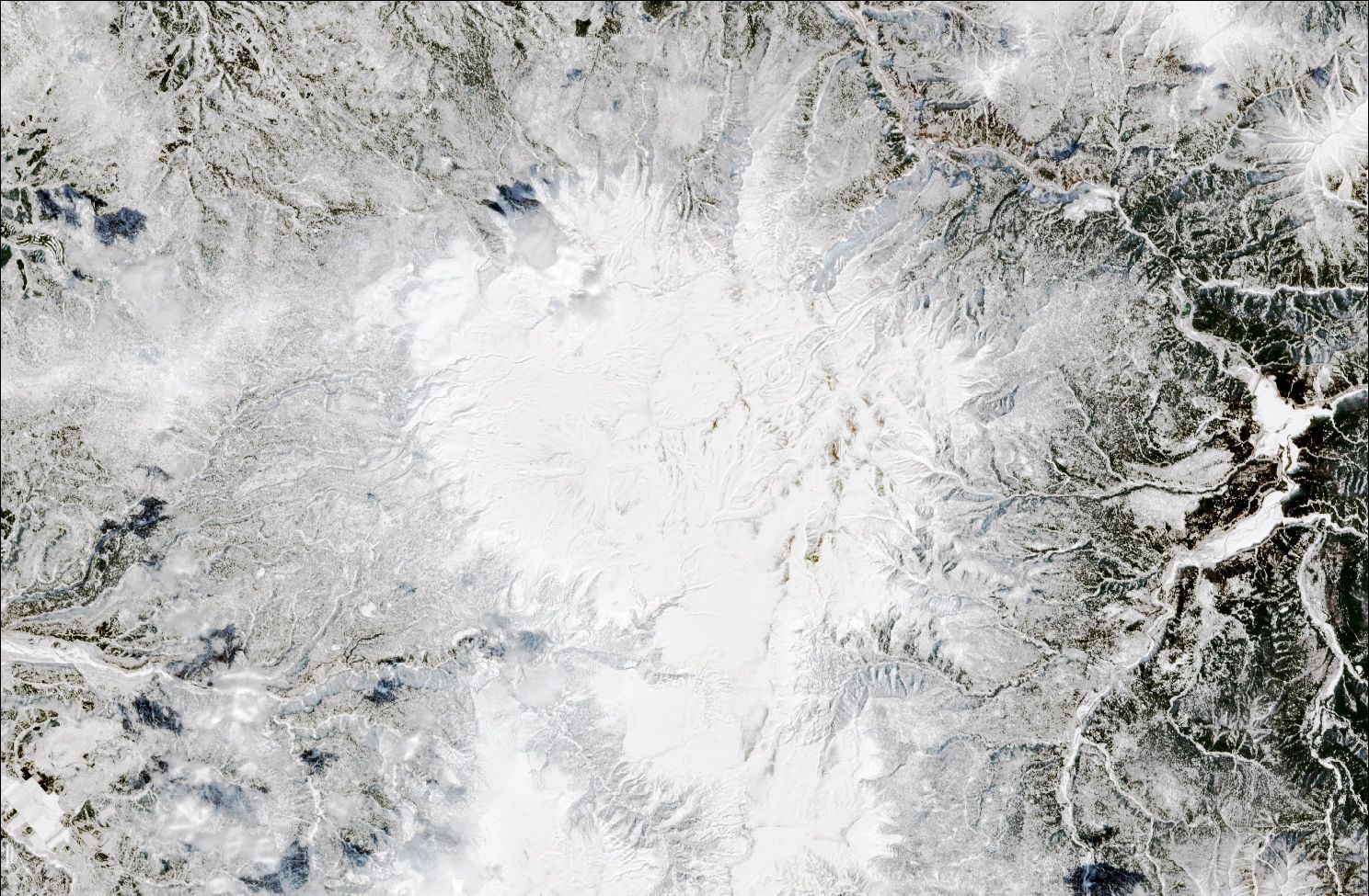 A satellite image showing snow over the northern Daisetsuzan mountains. The landscape is blanketed in white snow.