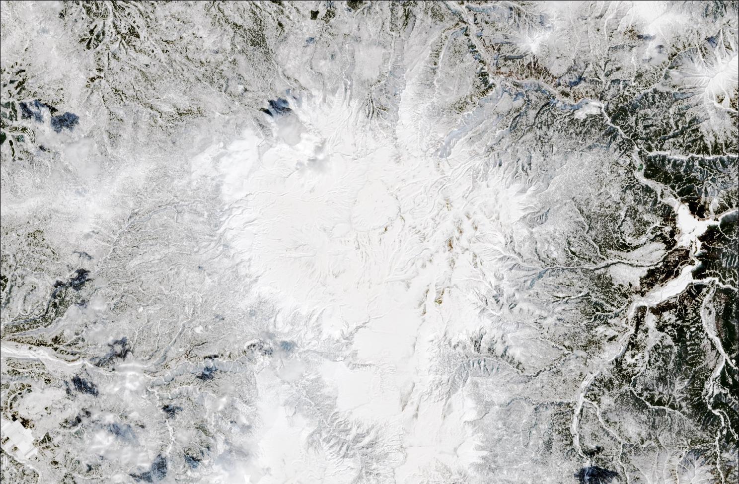 A satellite image showing snow over the northern Daisetsuzan mountains. The landscape is blanketed in white snow.