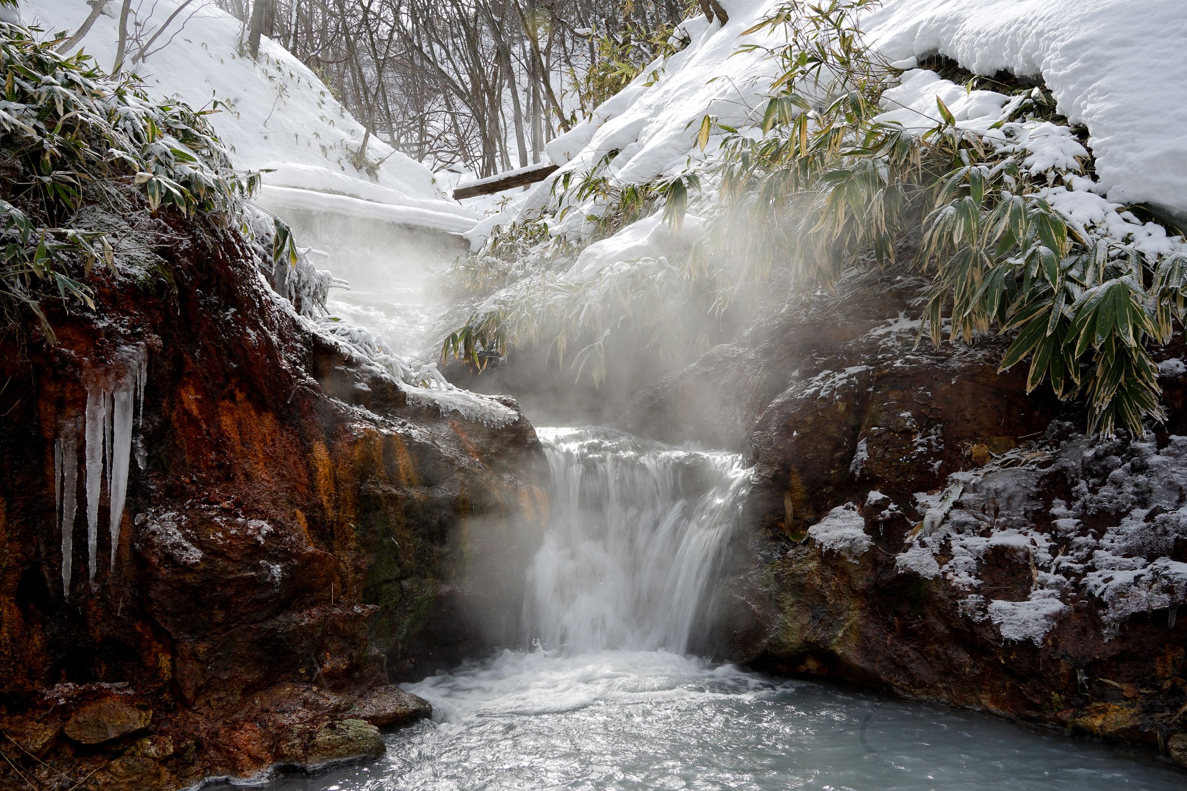 Oyunuma hot water running down the river in winter.