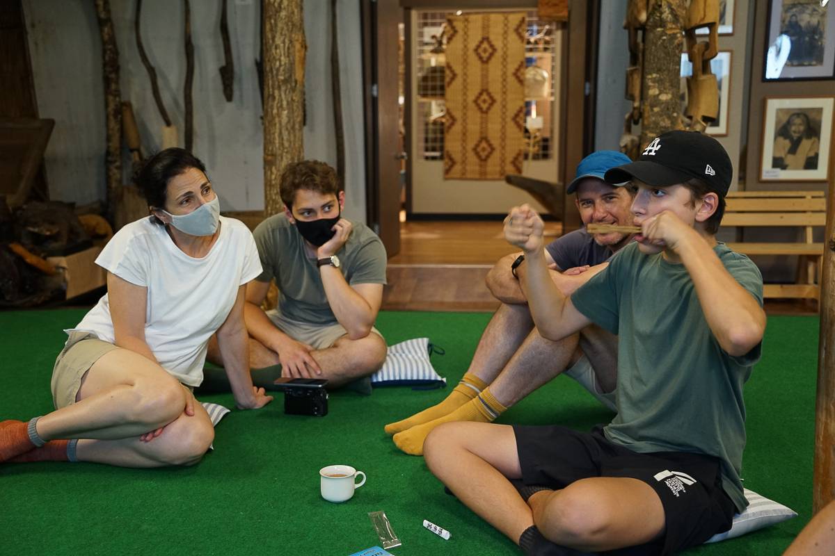 A tourist plays a traditional Ainu mouth harp