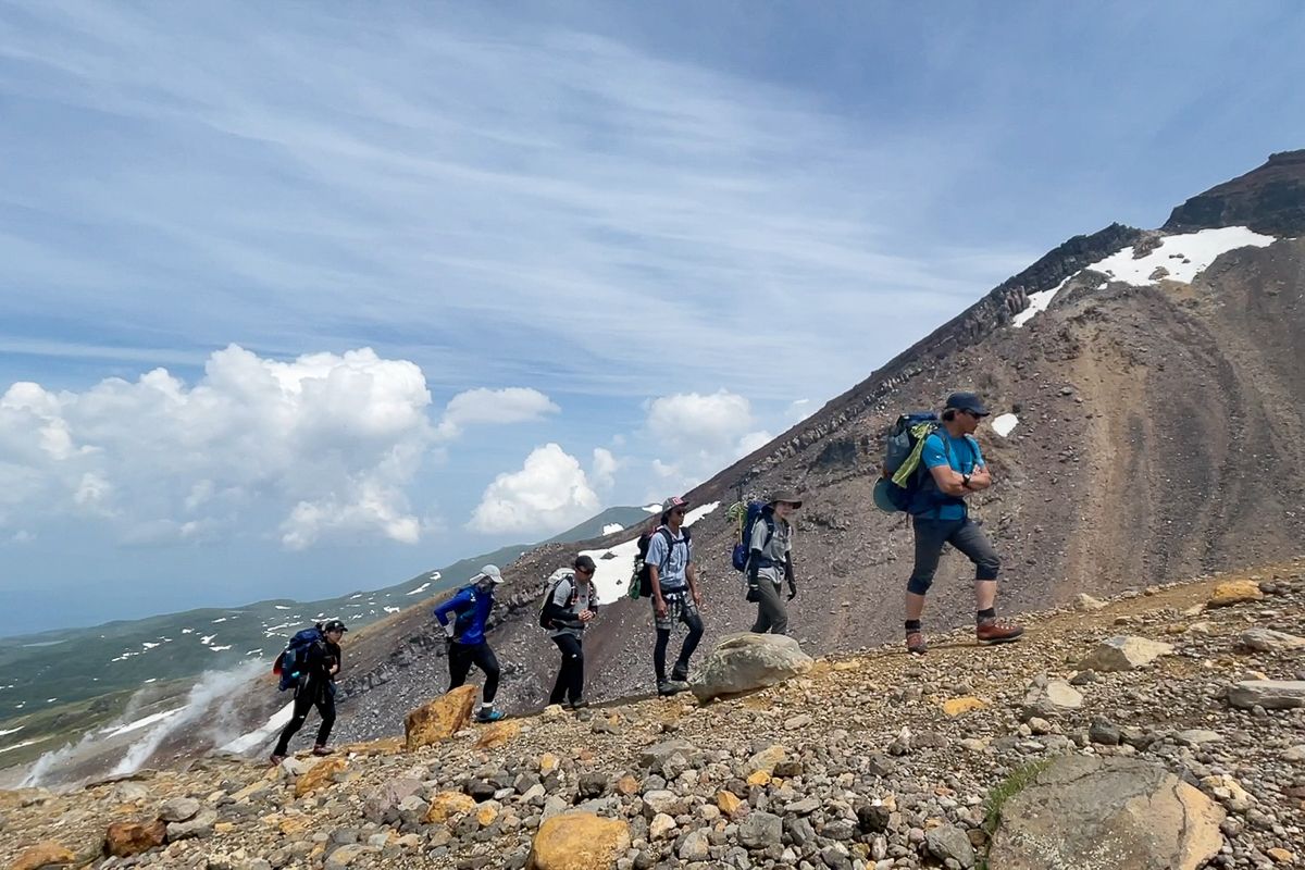Hikers on the ridgeline climbing Mt Asahidake, Daisetsuzan National Park, Hokkaido