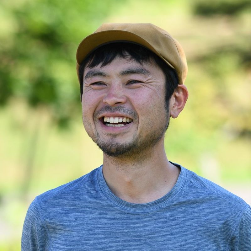 Adventure Hokkaido Guide Ayu smiles while wearing a yellow flat cap