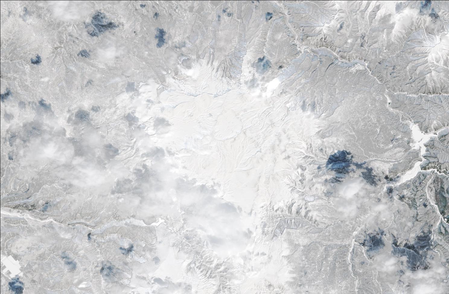 A satellite image showing snow over the northern Daisetsuzan mountains. The landscape is blanketed in white snow.