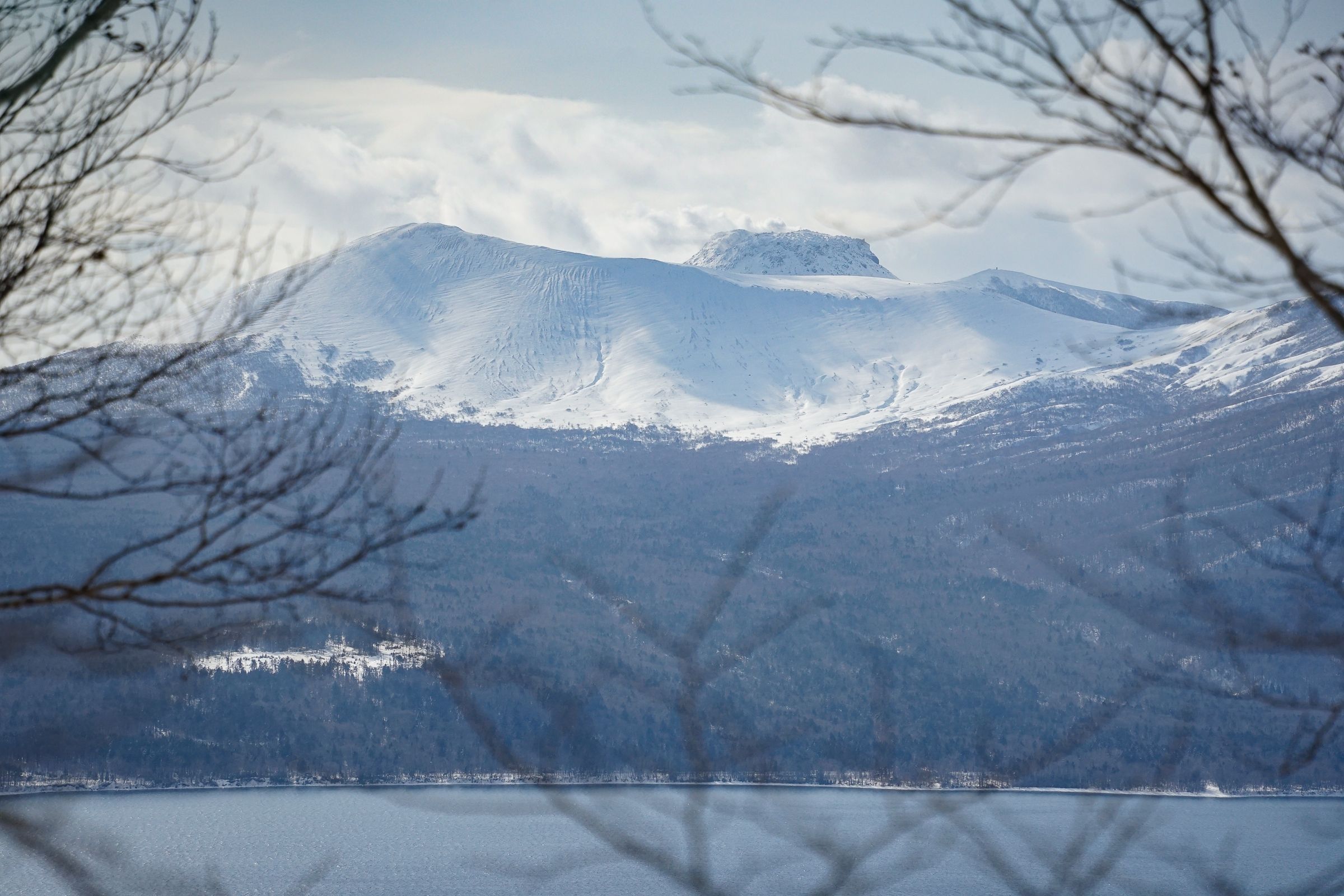 Snowcapped Mt. Tarumae viewed across Lake Shikotsu.