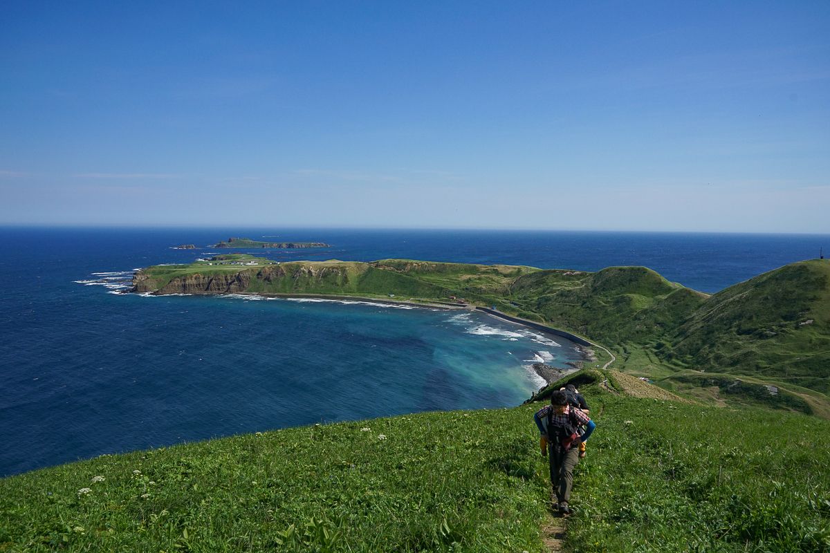 Hiker high about Cape Sukoton, on the Misaki Meguri hiking trail in Hokkaido