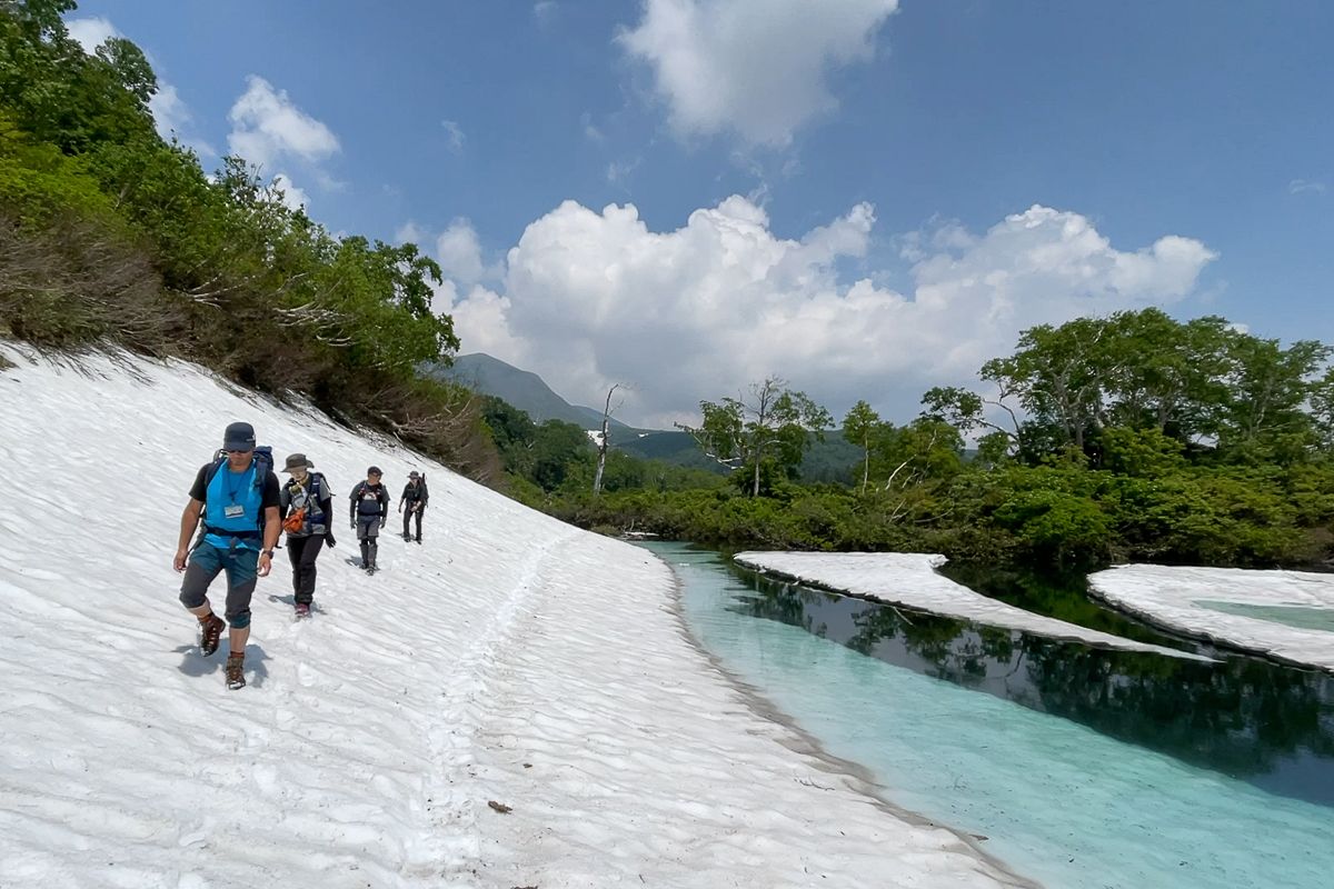 Hikers walking on snow at Ezonuma in Hokkaido