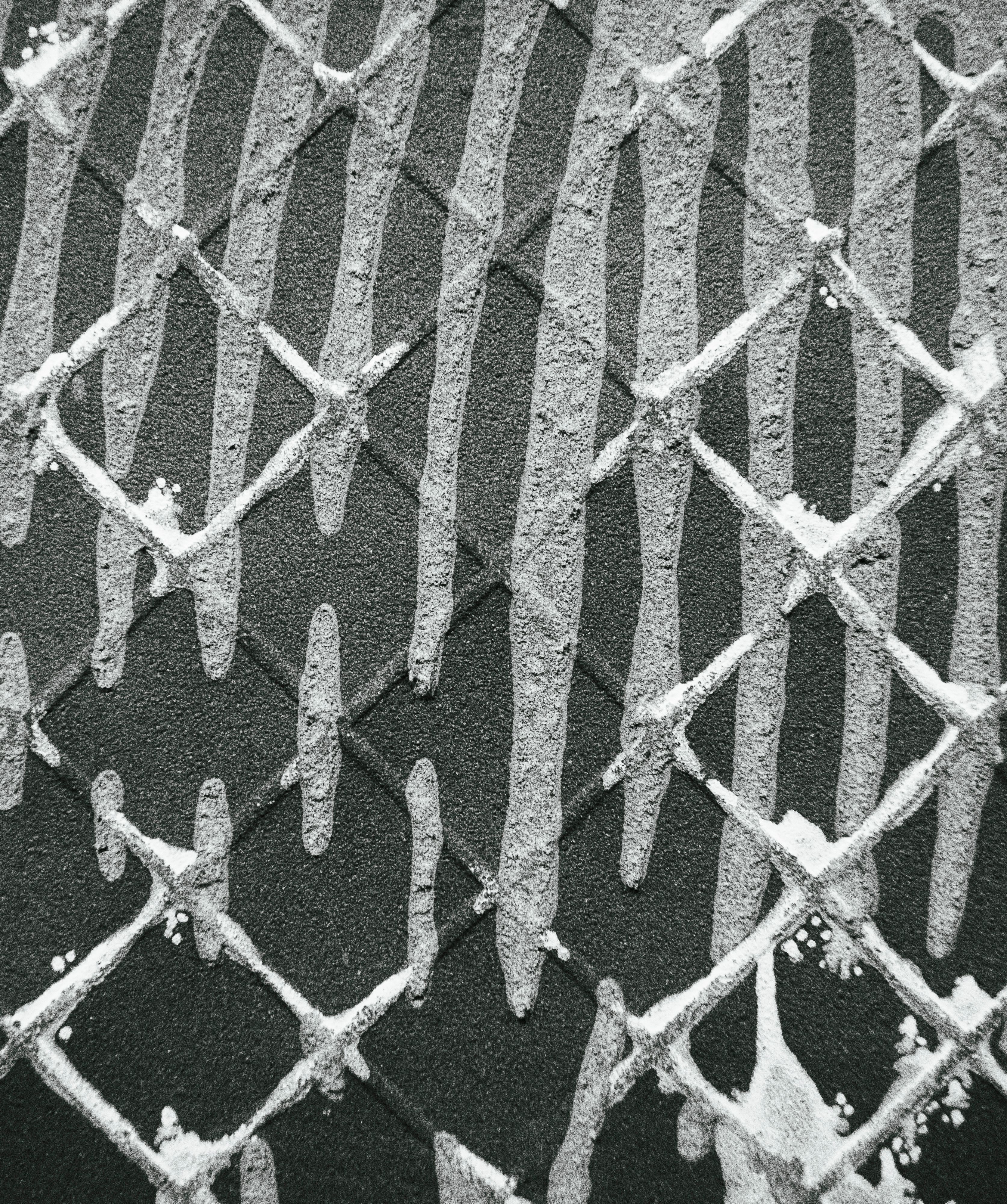 Grayscale diamond lattice pattern pressed into a textured wall surface