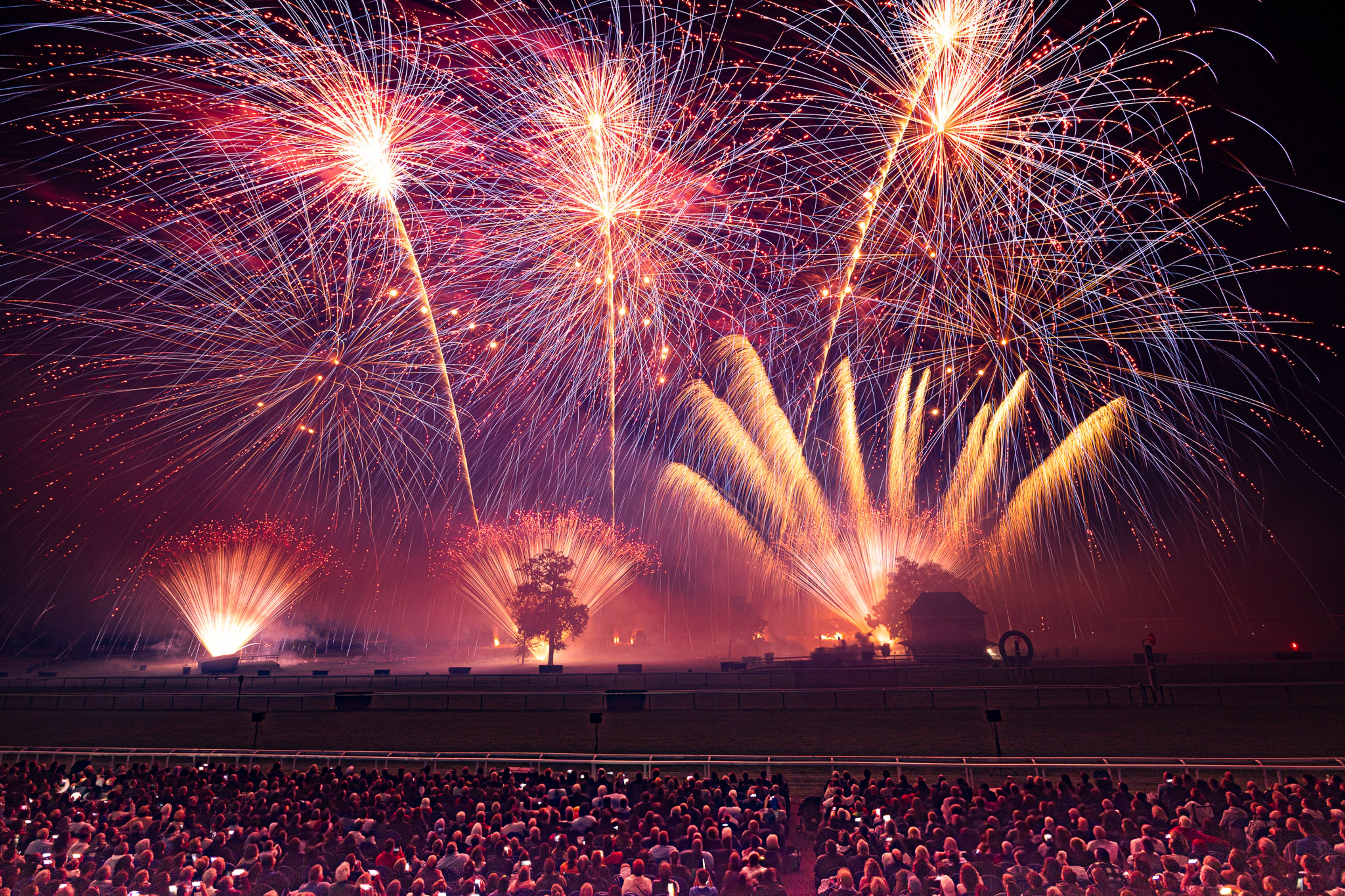 Red, gold and white fireworks above the crowd at Masters de Feu in Compiègne.