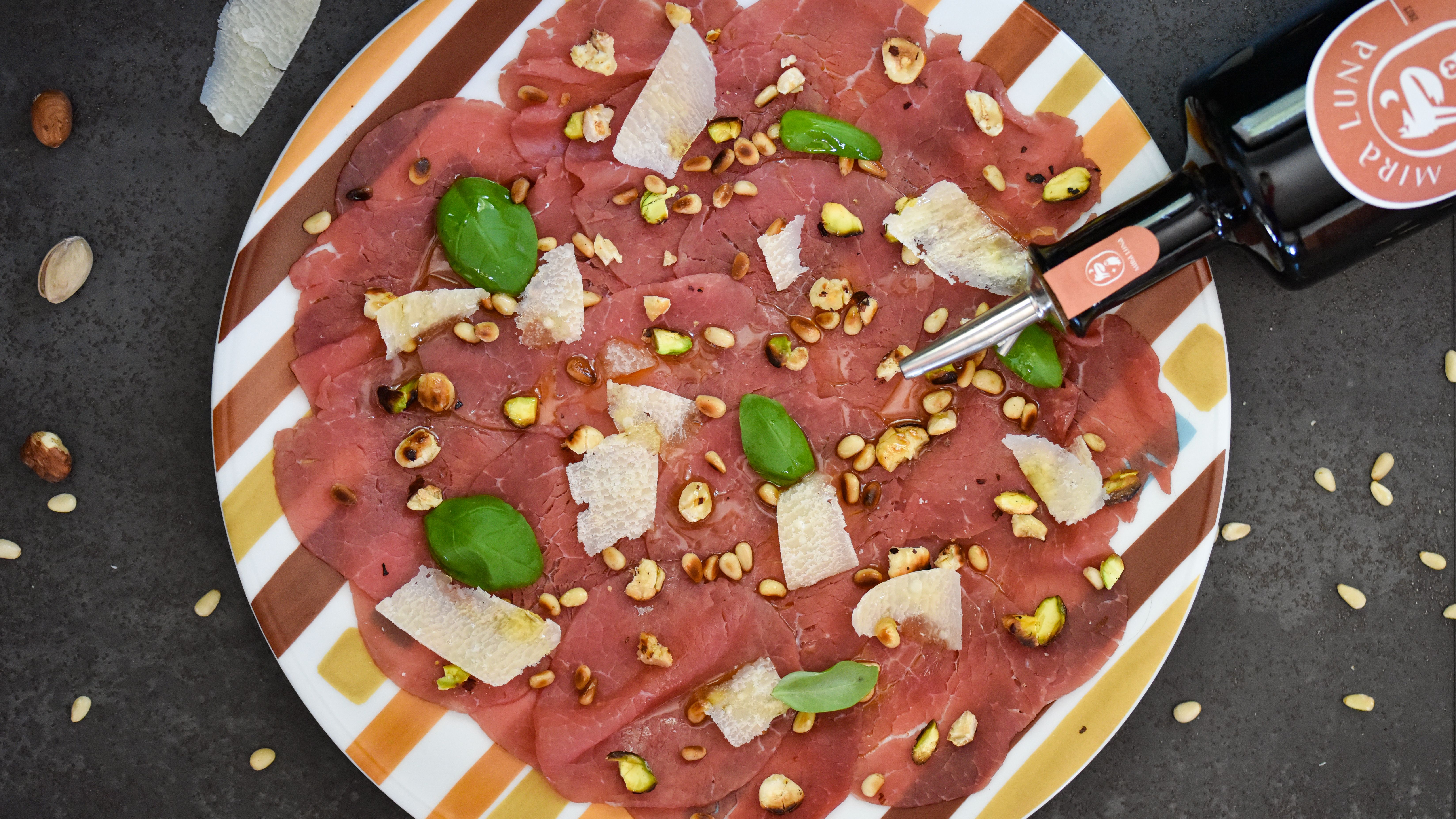 Beef carpaccio with pistachios and pine nuts