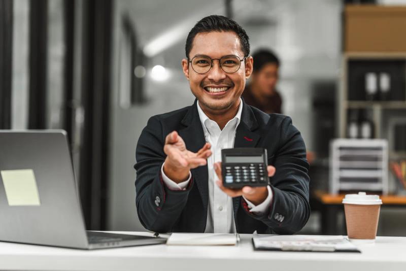 Calculator and laptop on a desk — analysing Google Ads cost per lead