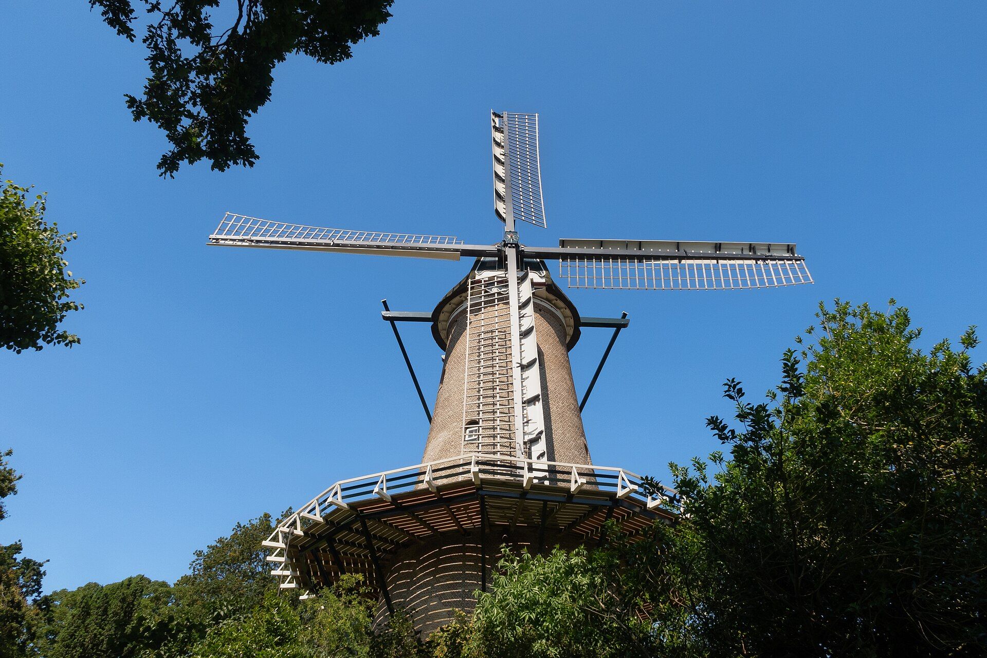 The Molen van Piet windmill above the trees at the edge of Alkmaar city centre on a summer day