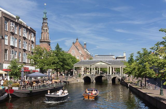 Leiden town hall and the Koornbrug bridge seen across the Nieuwe Rijn canal